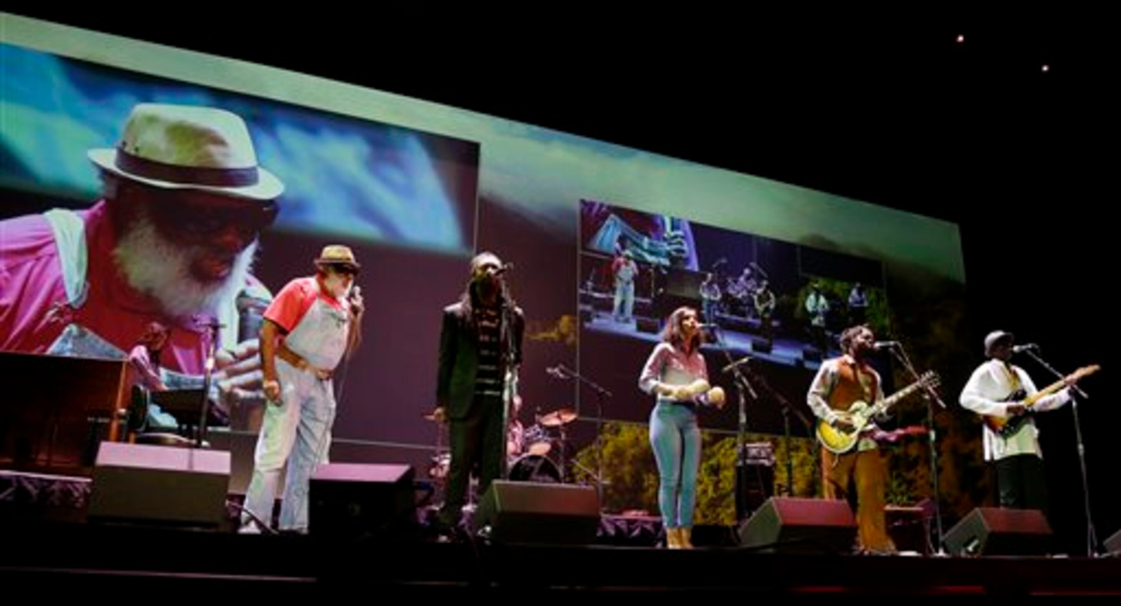The Playing For Change band performs Wednesday, March 19, 2014, at the Starbucks Coffee Company's annual shareholders meeting in Seattle. (AP Photo/Ted S. Warren)