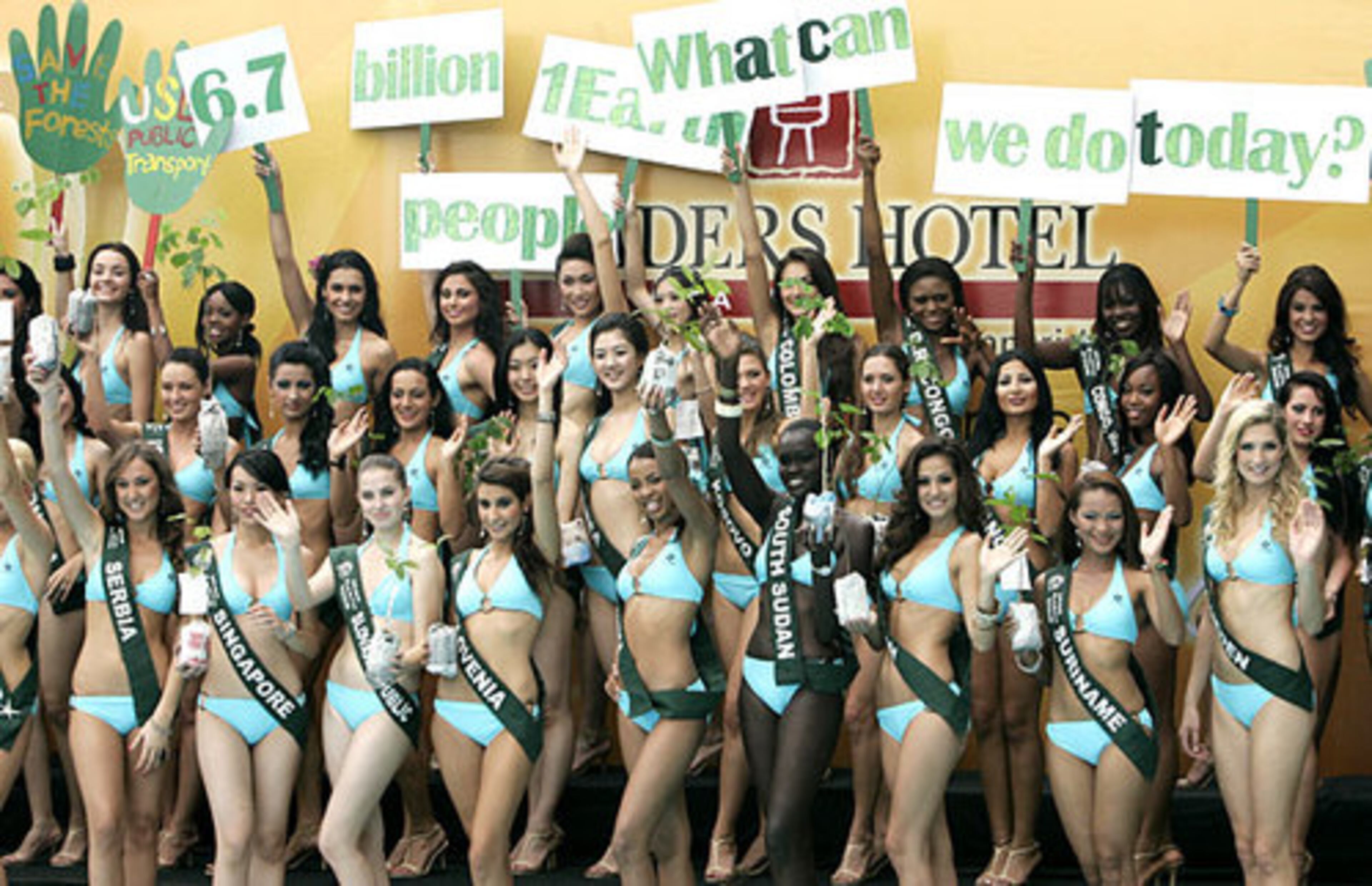 Candidates for the Miss Earth 2008 beauty pageant display messages while holding tree saplings as they were presented to the media .Eighty-five candidates from around the world are vying for the Miss Earth title.