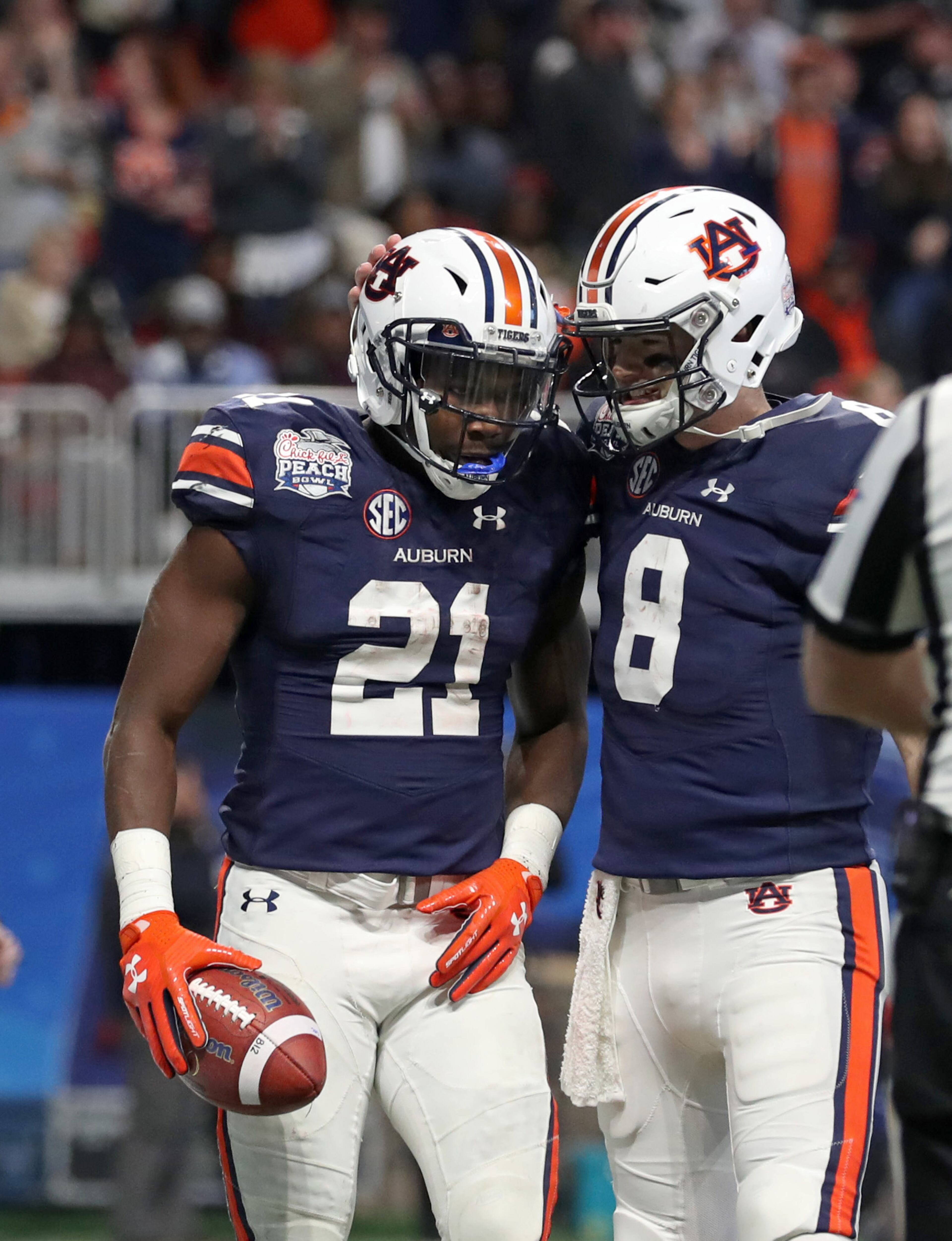 January 1, 2018 - Atlanta, Ga: Auburn Tigers running back Kerryon Johnson (21) celebrates his four-yard touchdown run with quarterback Jarrett Stidham (8) during the third quarter against the UCF Knights in the Chick-fil-a Peach Bowl at the Mercedes-Benz Stadium Monday, January 1, 2018, in Atlanta. The UCF Knights won 34-27. PHOTO / JASON GETZ