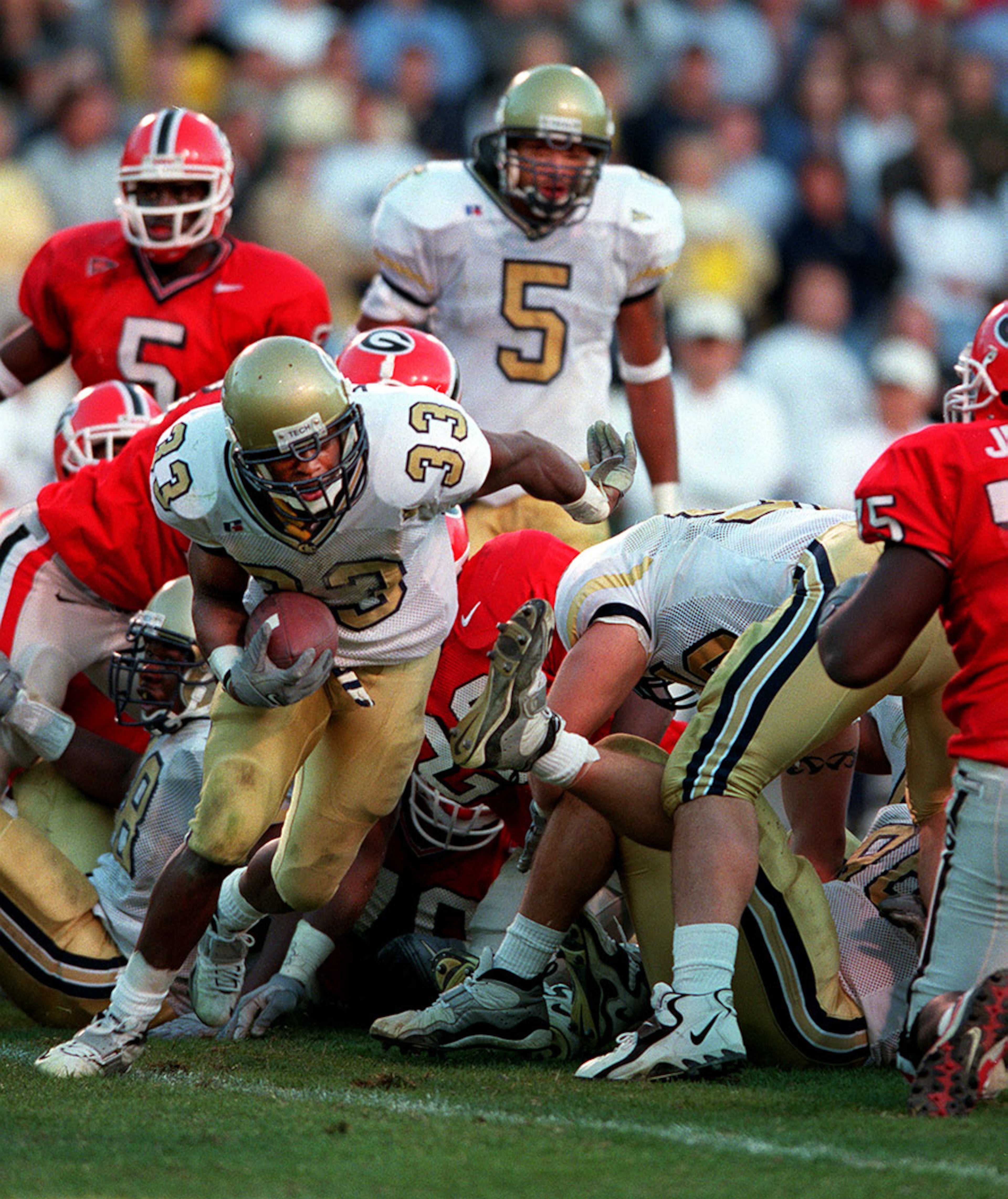 Georgia Tech safety Chris Young (33) scoops up a fumble by Georgia’s Jasper Sanks (28, in the pile) at the 1-yard line with 13 seconds left in regulation of the 1999 Tech-Georgia game. The controversial play still dogs Sanks. He was never able to redeem himself against the Jackets as he was kicked off the team the week prior to the 2001 rematch.