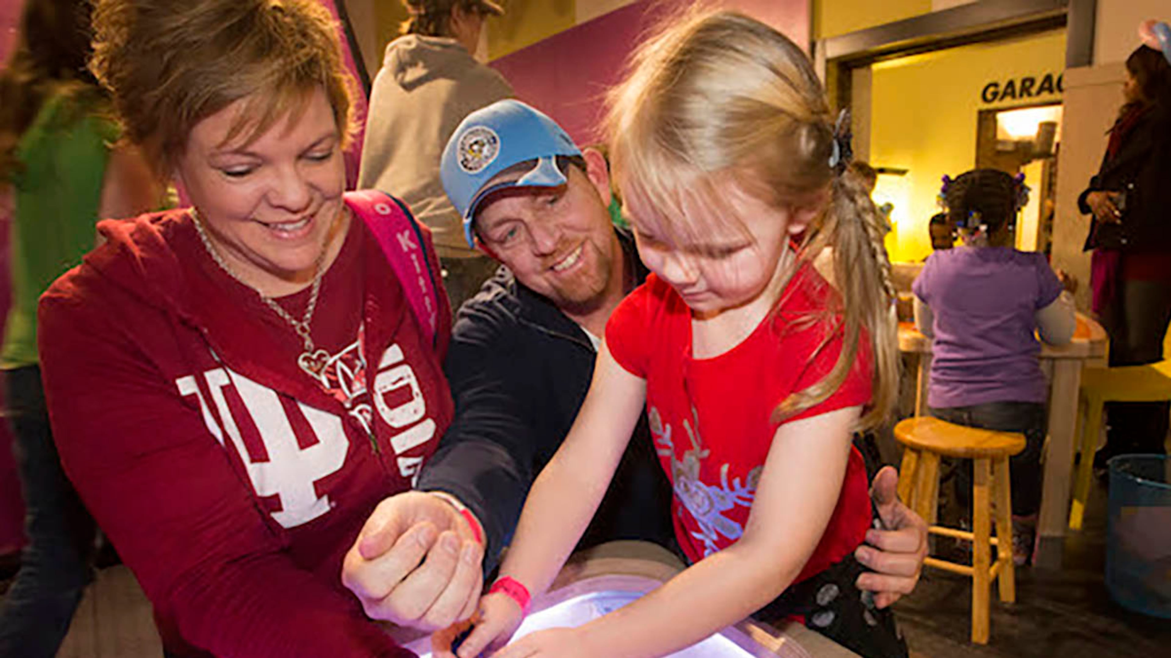 At the Children's Museum of Pittsburgh, parents and children explore the various stations of "XOXO: An Exhibit About Love & Forgiveness."