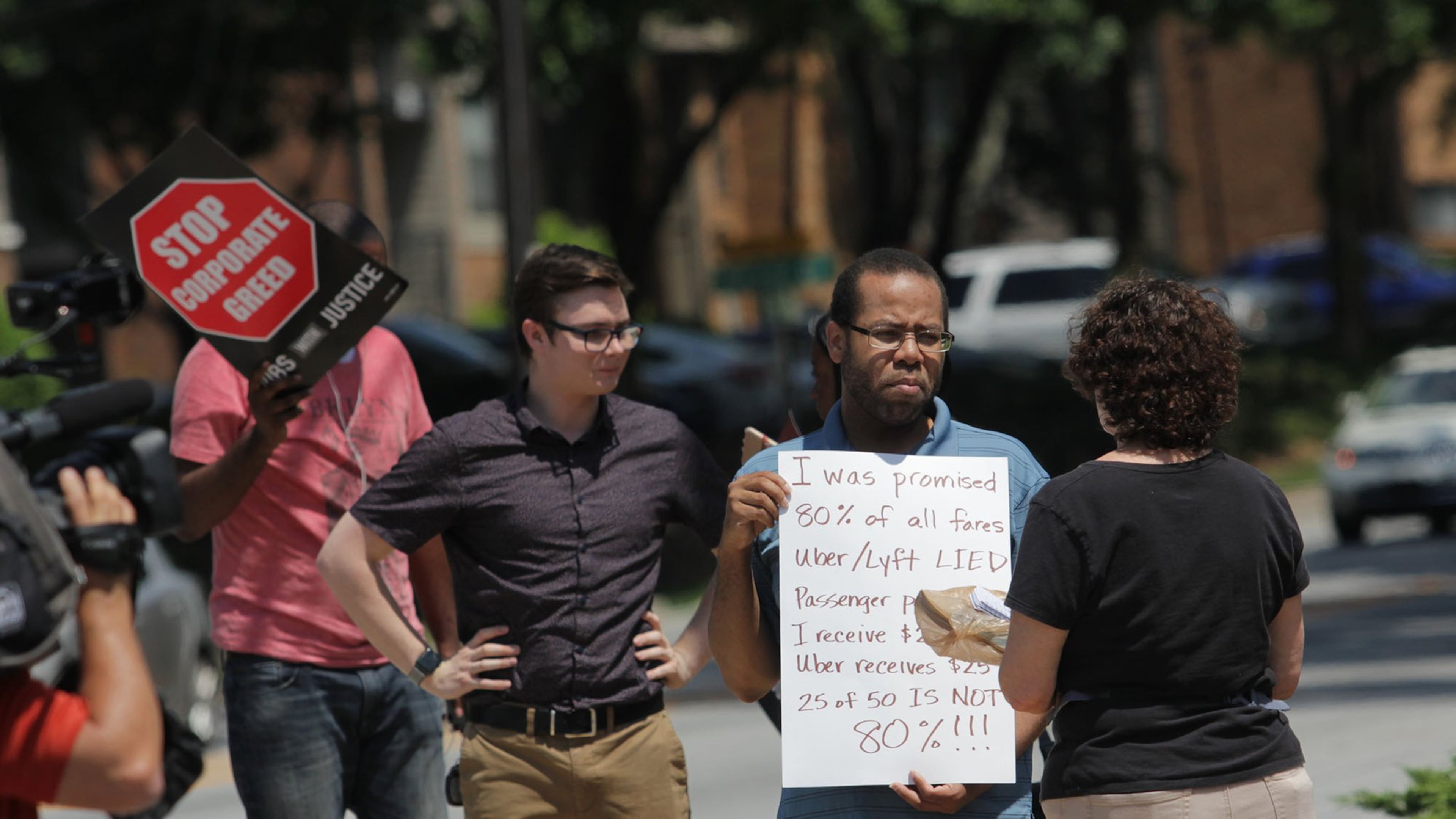 Ride-share drivers from Uber and Lyft rallied for higher wages near the entrance of the Uber office park in Atlanta. (Akili-Casundria Ramsess/Eye of Ramsess Media)