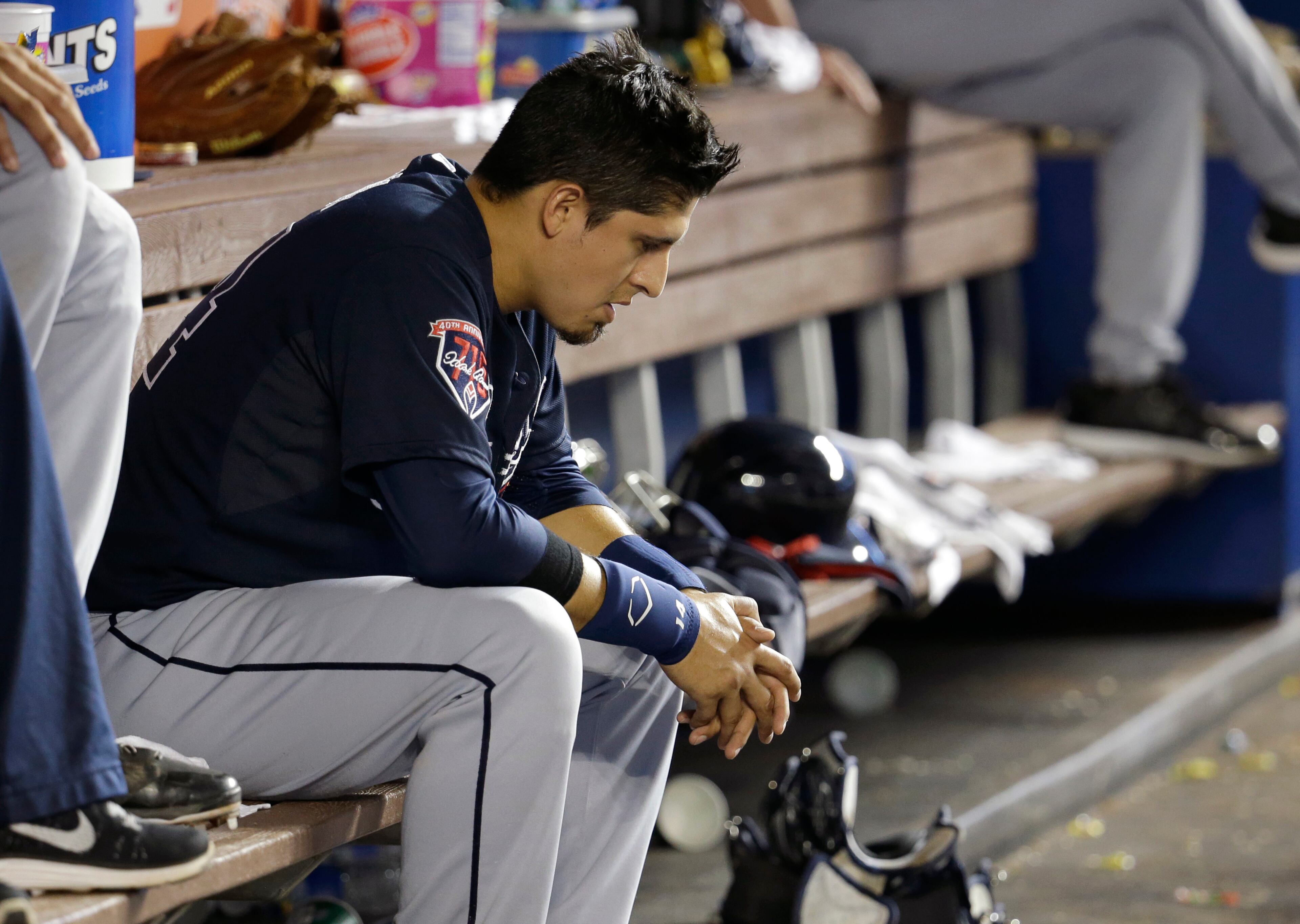 Atlanta Braves' Ramiro Pena sits in the dugout in the ninth inning of a baseball game against the Miami Marlins, Thursday, May 1, 2014, in Miami. The Marlins defeated the Braves 5-4. Pena struck out with the bases loaded in the eighth inning. (AP Photo/Lynne Sladky)