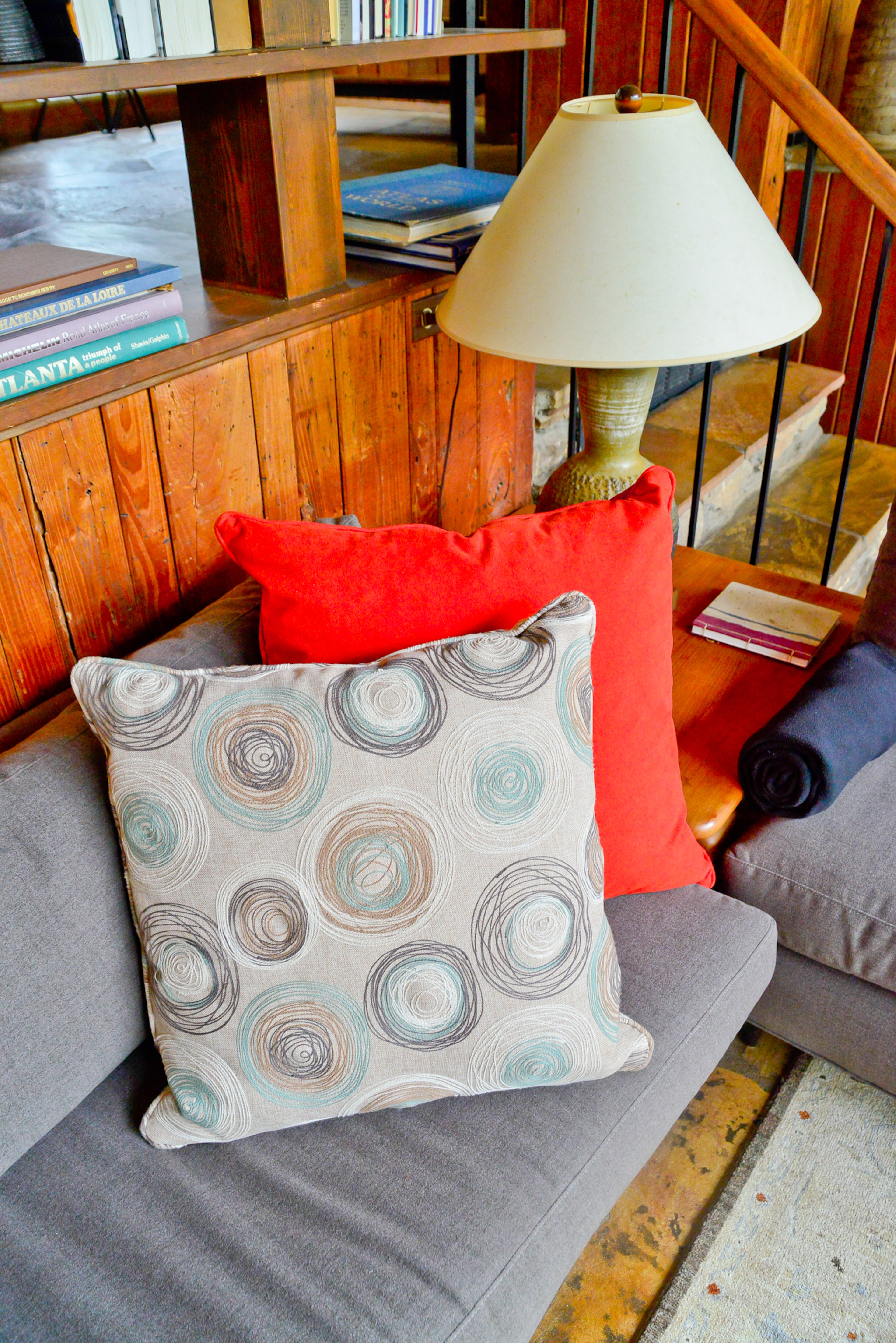 The home's mid-century modern design includes built-in seating, such as this gray upholstered couch.