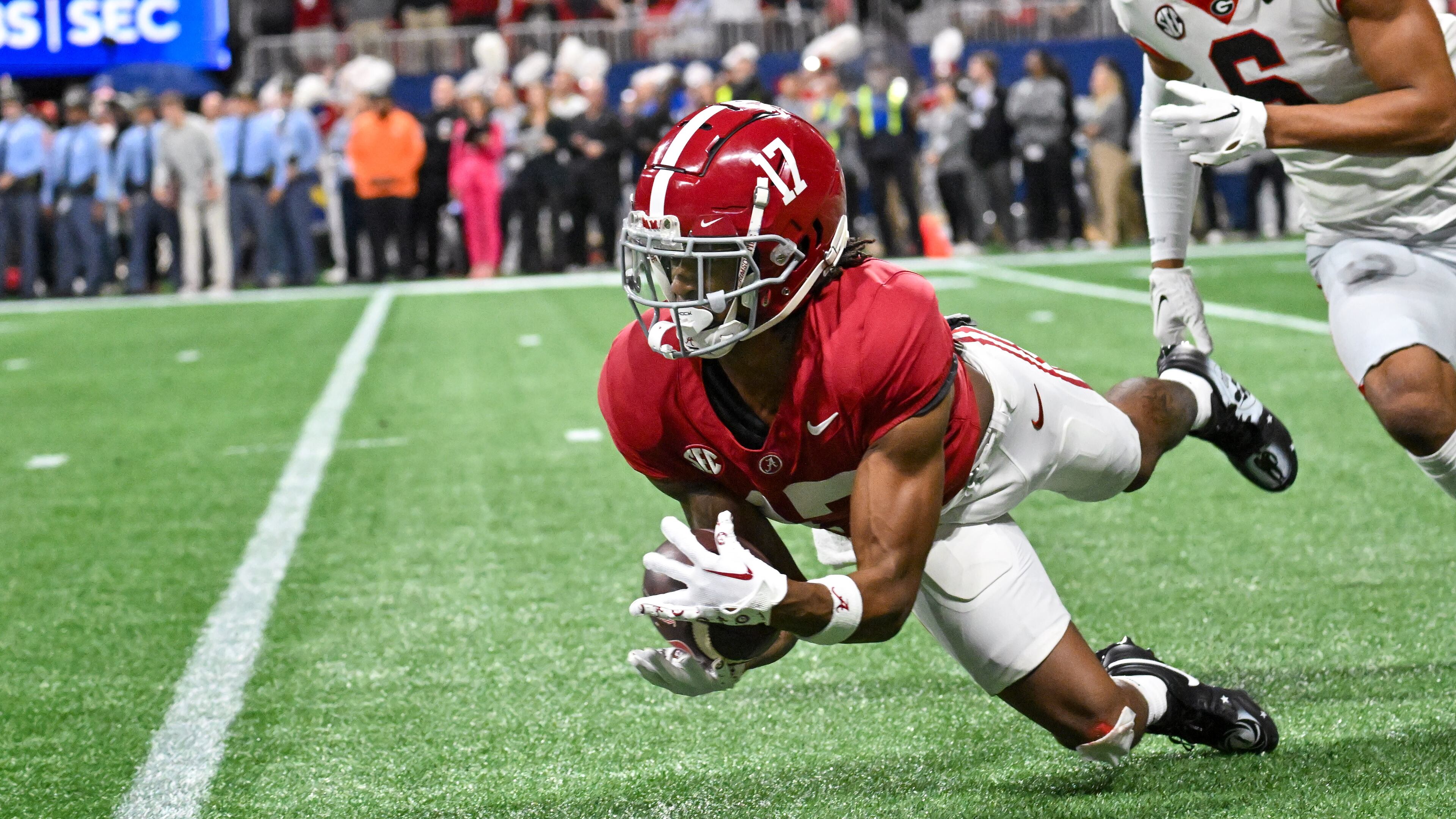 Alabama Crimson Tide wide receiver Isaiah Bond (17) makes a catch in front of Georgia Bulldogs defensive back Daylen Everette (6) during the first half of the SEC Championship football game at the Mercedes-Benz Stadium in Atlanta, on Saturday, December 2, 2023. (Hyosub Shin / Hyosub.Shin@ajc.com)