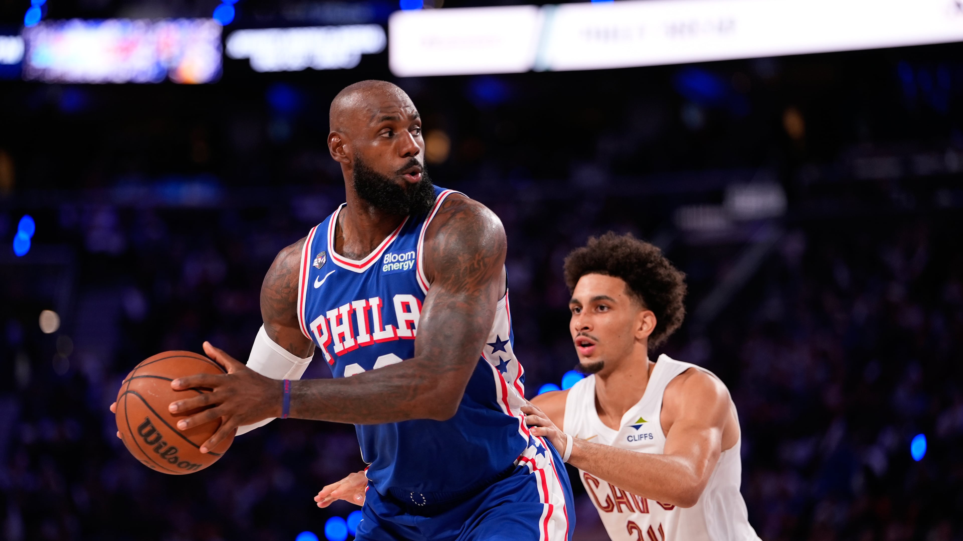 Philadelphia 76ers' LeBron James, left, tries to get past Cleveland Cavaliers' Tyrese Proctor during the first half of an NBA basketball game Thursday, Oct. 22, 2026, in Philadelphia. (AP Photo/Matt Slocum)