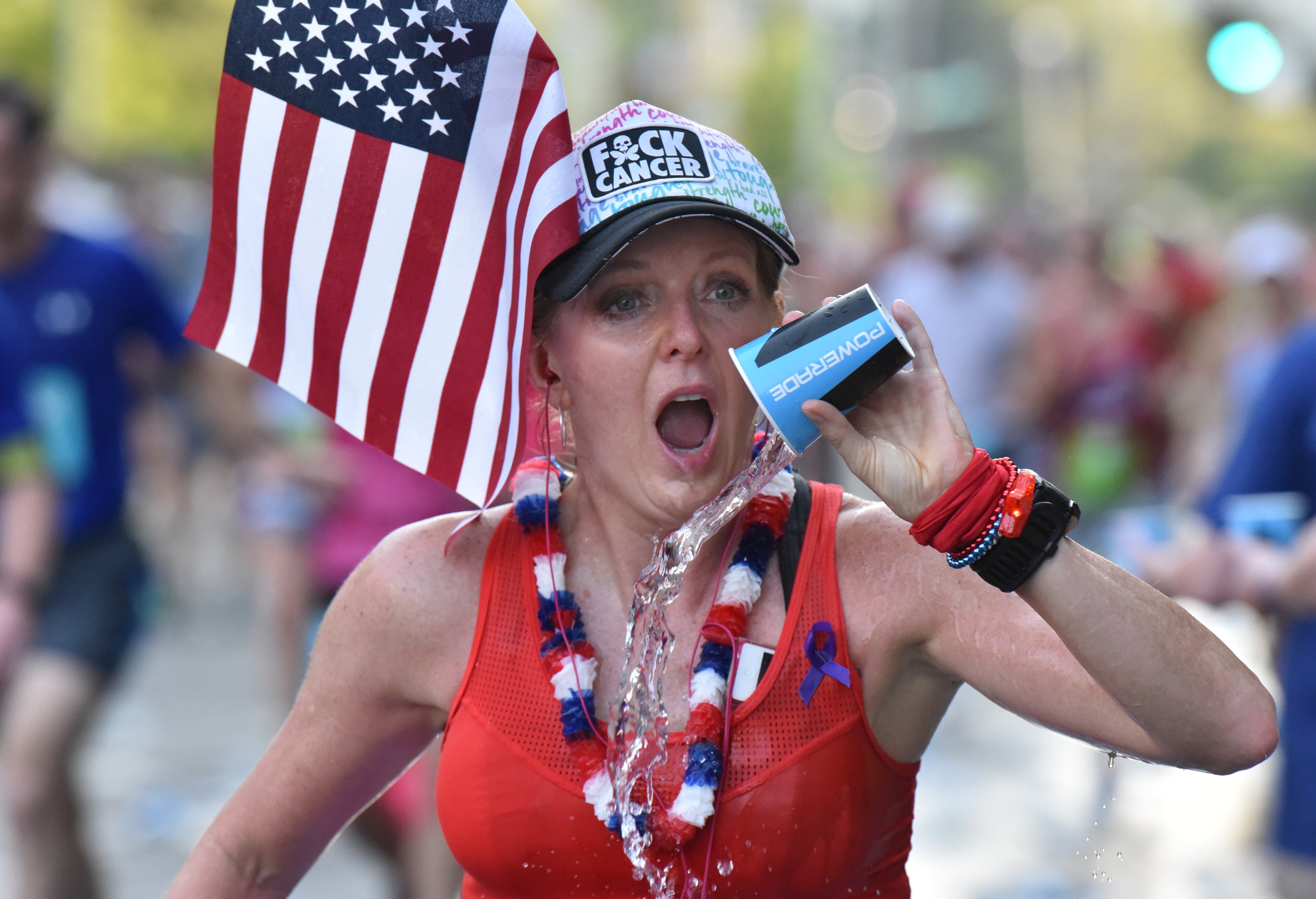July 4, 2018 Atlanta - Runners cool off at a water station on the top of Cardiac Hill during the AJC Peachtree Road Race on Wednesday, July 4, 2018. HYOSUB SHIN / HSHIN@AJC.COM