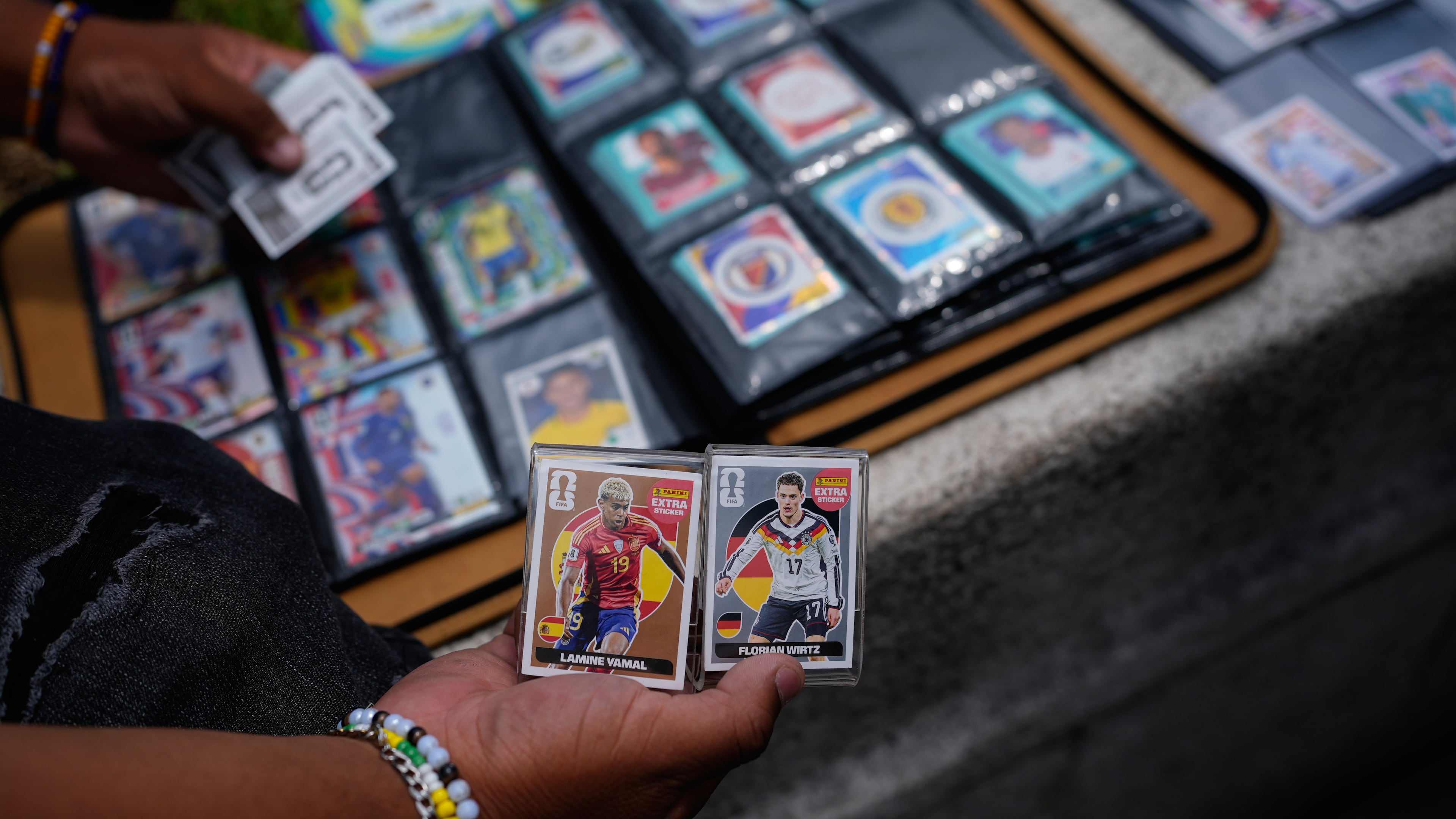 Youth exchange Panini World Cup stickers in Mexico City, Tuesday, June 16, 2026. (AP Photo/Marco Ugarte)