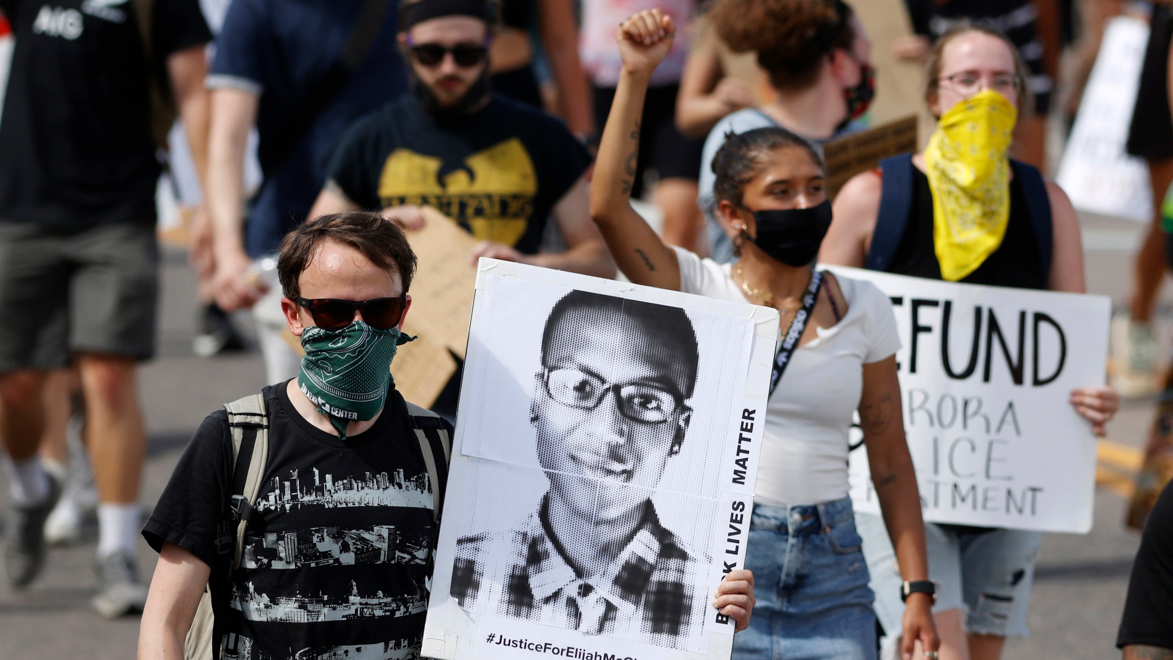 FILE - A demonstrator carries an image of Elijah McClain during a rally and march, June 27, 2020, in Aurora, Colo. Two paramedics were convicted Friday, Dec. 22, 2023, in the 2019 killing of McClain, who they injected with an overdose of the sedative ketamine after police put him in a neck hold. (AP Photo/David Zalubowski, File)
