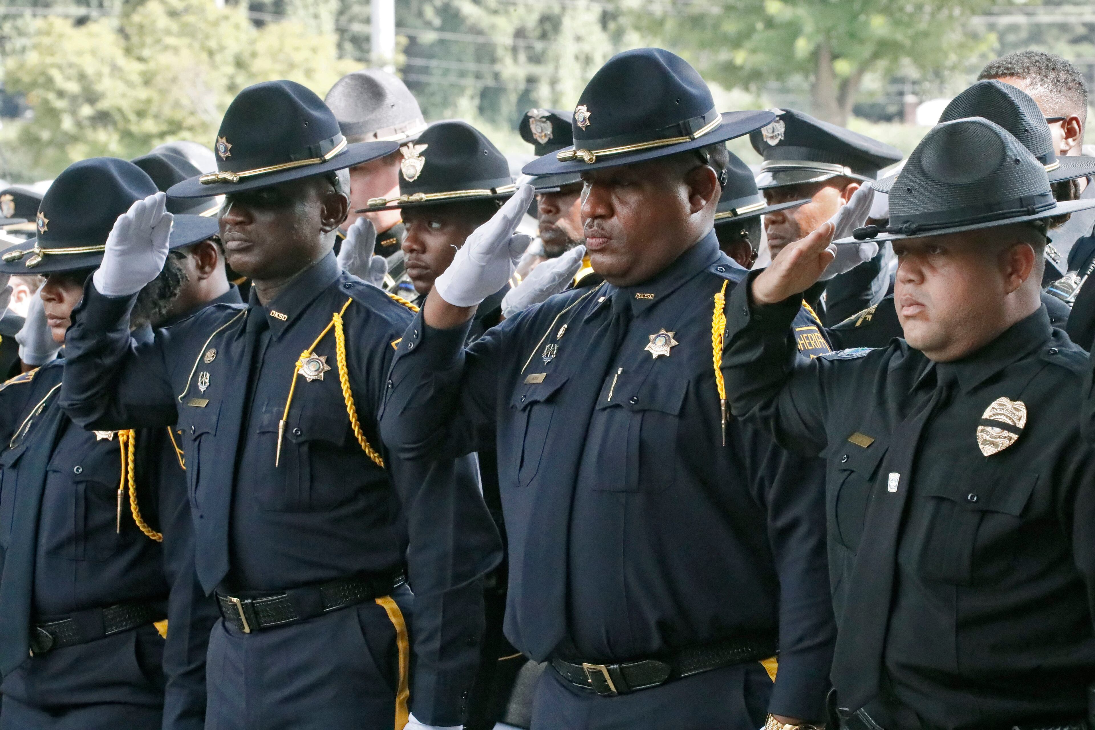 July 11, 2019, 2019 - Gainesville - Honor Guard members from police departments throughout Georgia salute as family members of slain Hall County Sheriff's Deputy Nicolas Blane Dixon enter the church. A funeral service was held for slain Hall County Sheriff's Deputy Nicolas Blane Dixon, the fourth Georgia law enforcement officer killed in the line of duty this year. The service was held at Free Chapel Worship Center in Gainesville. Bob Andres / bandres@ajc.com