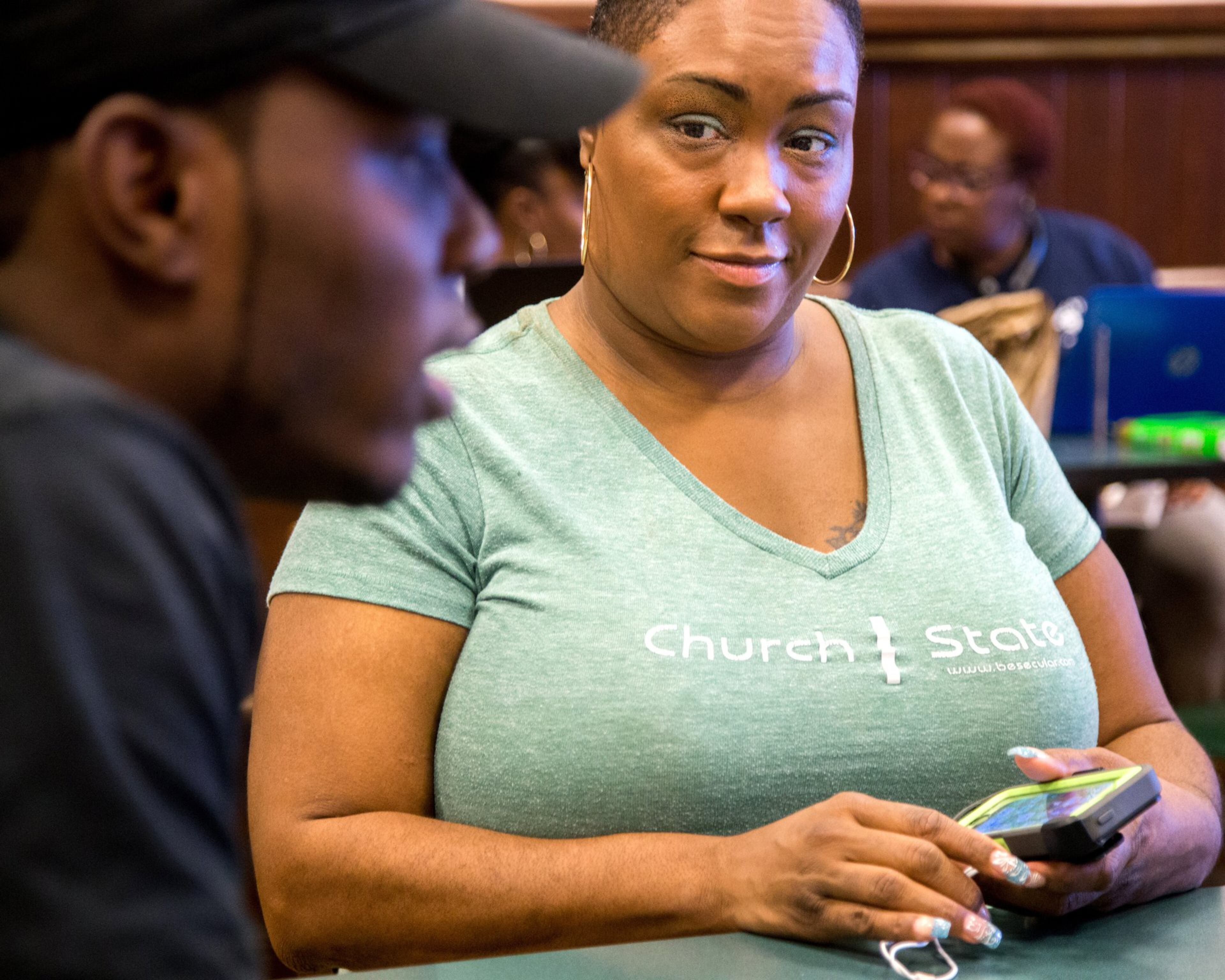 President and founder Mandisa Thomas listens to Deric McNealy talk about how he came to the realization he was an atheist during a meeting of the Black Nonbelievers last fall in Morrow. STEVE SCHAEFER / SPECIAL TO THE AJC