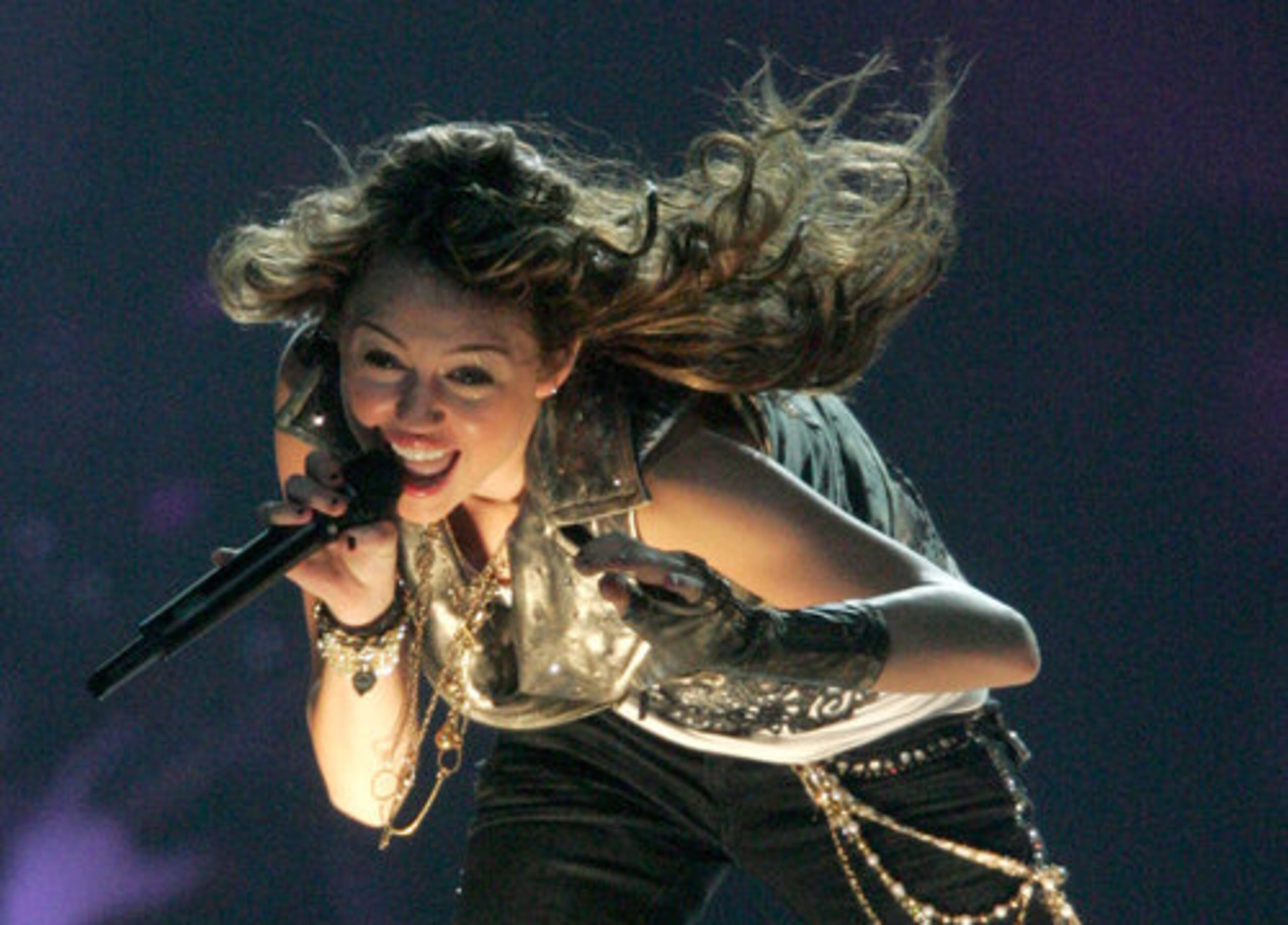 "Hannah Montana" star Miley Cyrus was shot for Vanity Fair wearing a blanket and showing her bare back, leading to a wave of media hysteria over the "Miley Cyrus topless photos."