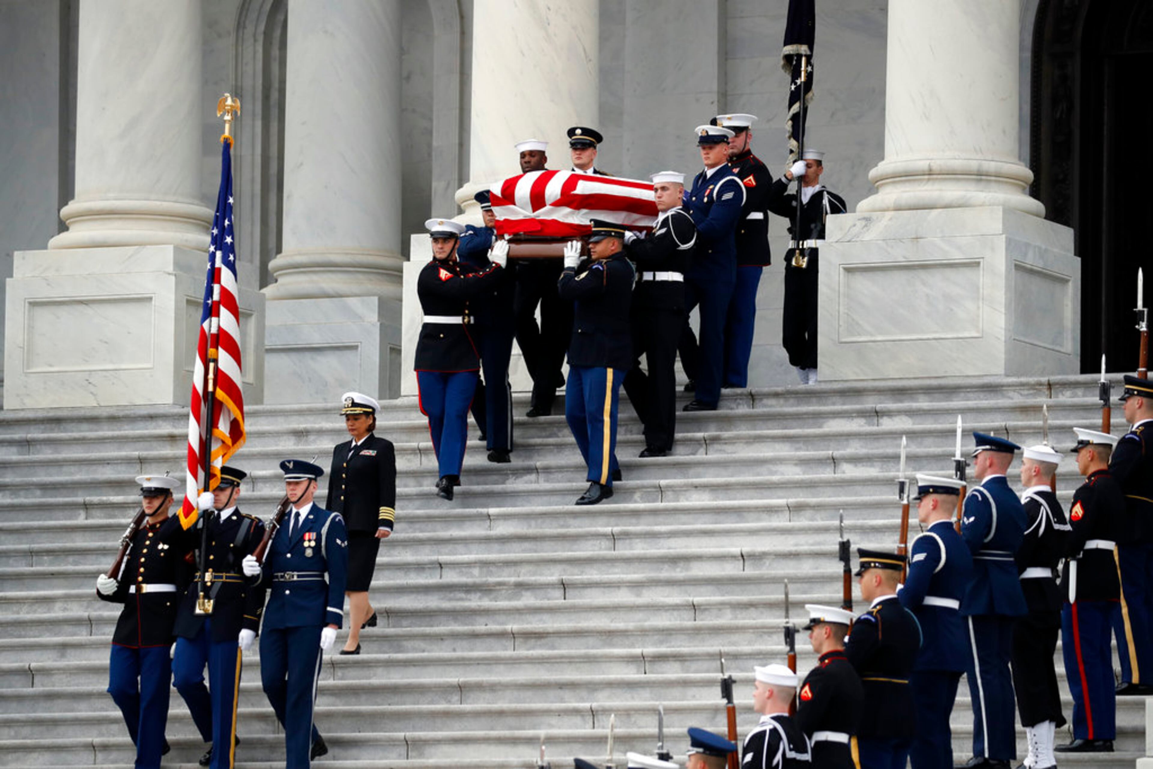 The flag-draped casket of former President George H.W. Bush is carried by a joint services military honor guard from the U.S. Capitol, Wednesday, Dec. 5, 2018, in Washington. (AP Photo/Alex Brandon, Pool)