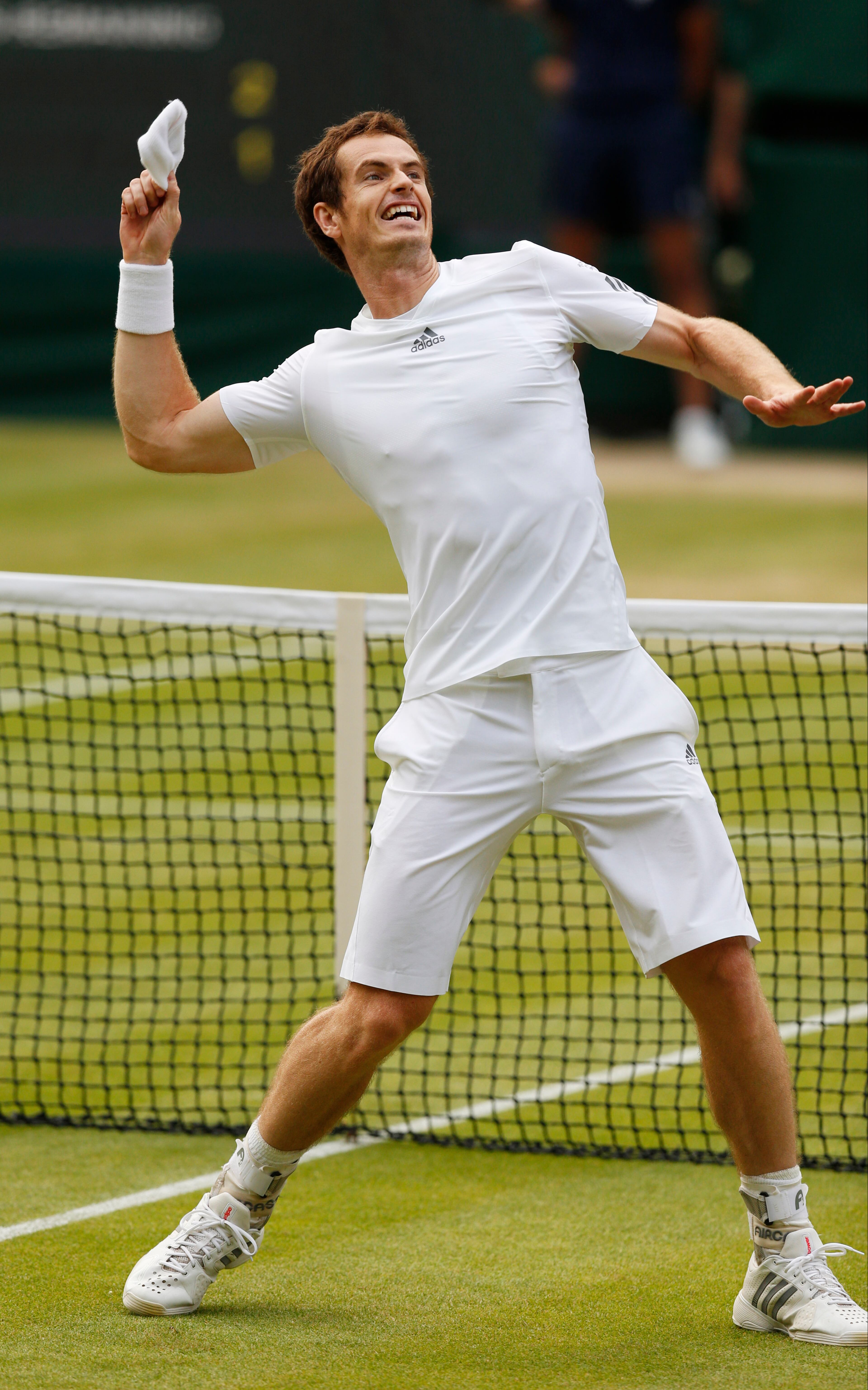 Andy Murray of Britain throws his wristband to the crowd after defeating Fernando Verdasco of Spain in their Men's singles quarterfinal match at the All England Lawn Tennis Championships in Wimbledon, London, Wednesday, July 3, 2013. (AP Photo/Jonathan Brady)