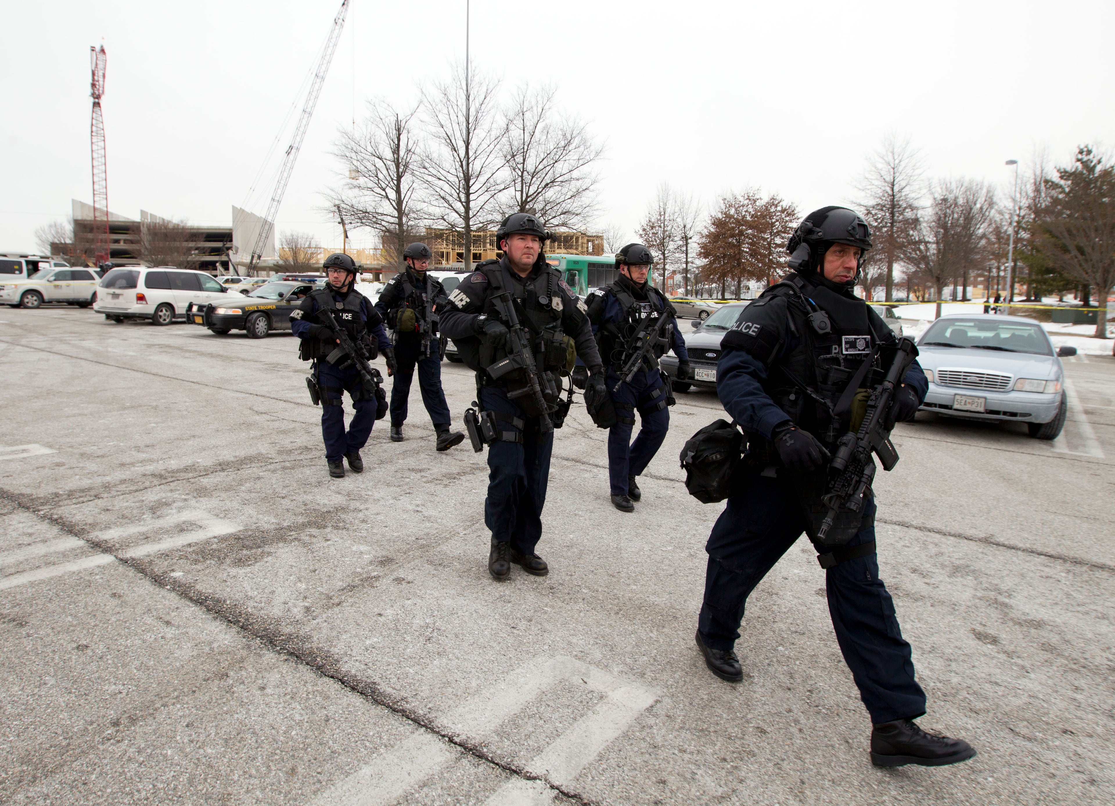 Police move in from a parking lot to the Mall in Columbia after reports of a multiple shooting on Jan. 25, 2014, in Columbia, Md.
