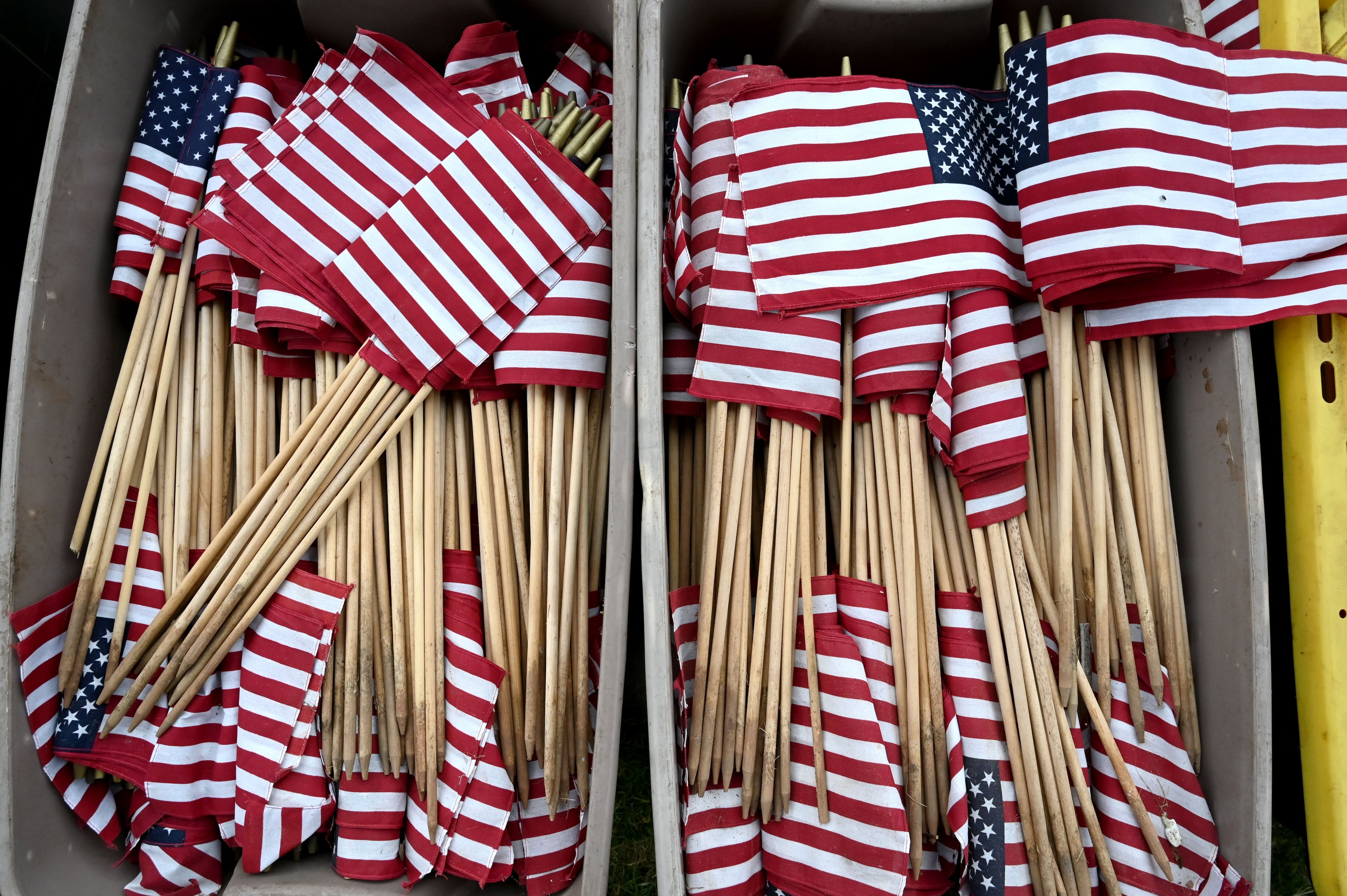 American flags are set out ahead of the Memorial Day Flag Placement event at Marietta National Cemetery on Saturday, May 23, 2026, in Marietta. Scouting groups in the community place more than 18,000 U.S. veteran grave flags at Marietta National Cemetery each year on the Saturday before Memorial Day, helping prepare for Monday’s ceremony. The long-running service project—organized with the National Memorial Day Association of Georgia—also gives youth and adults an opportunity to honor fallen service members and learn about their sacrifices and the area’s history. (Hyosub Shin/AJC)