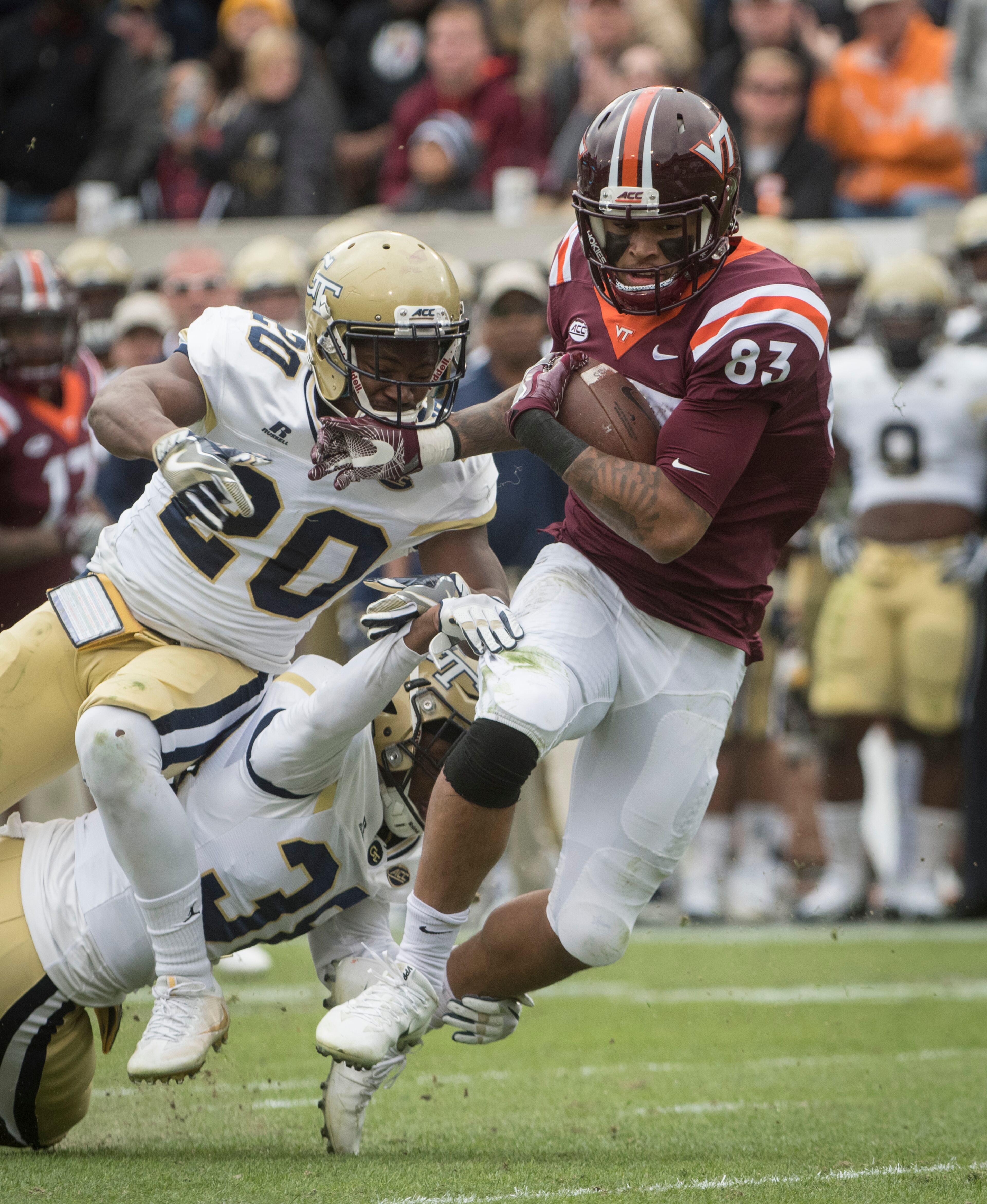 Virginia Tech wide receiver Eric Kumah (83) tries to break free from Georgia Tech defensive back Lawrence Austin (20) and Georgia Tech defensive back Dameon Williams (39) during the second half of a football game on Saturday, Nov.11, 2017, in Atlanta. (Photo/John Amis)
