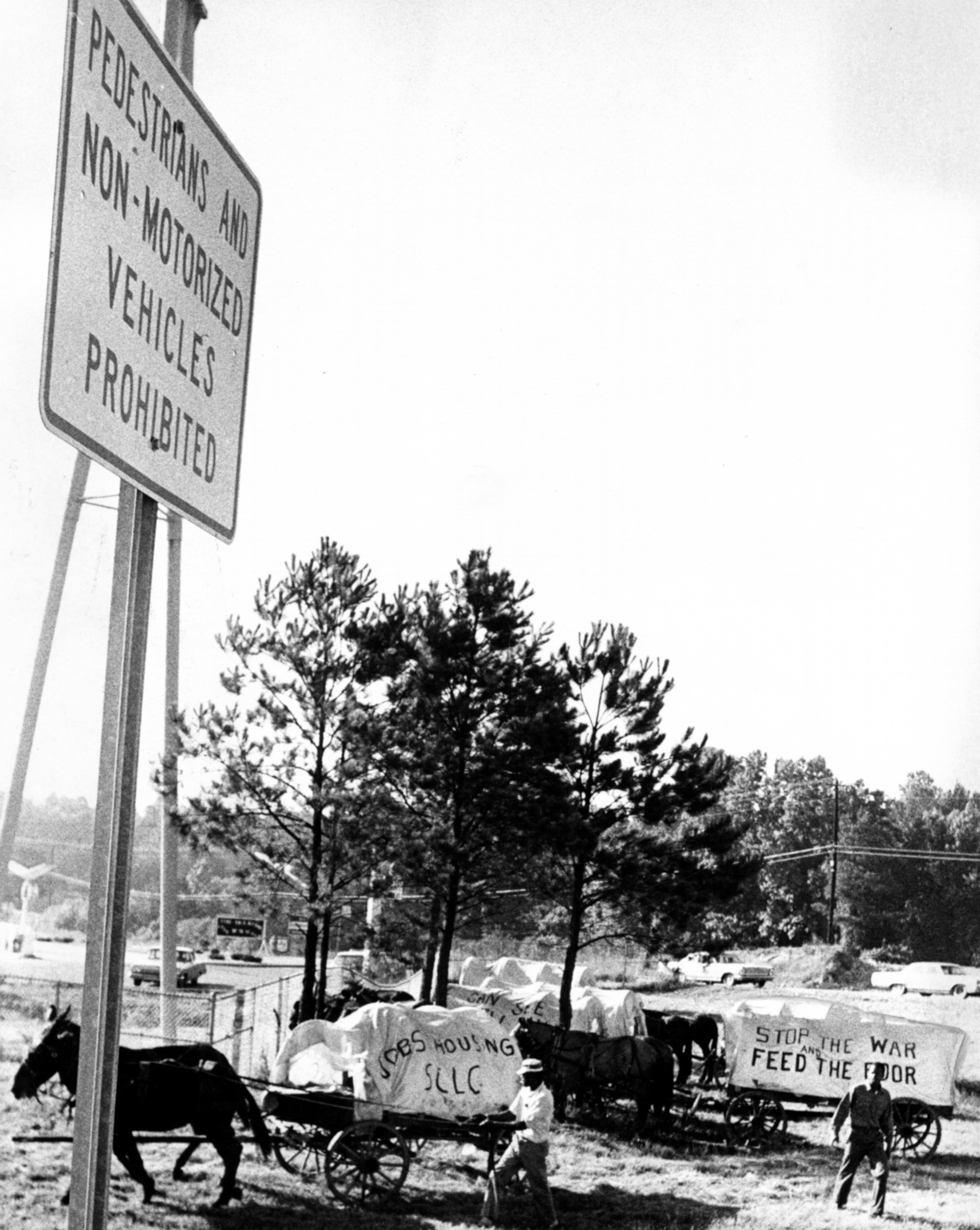 June, 1968 - Sign (left) along interstate forbids pedestrians, non-motorized traffic on I-20. Wagon train members stopped by highway patrolmen near Douglasville.