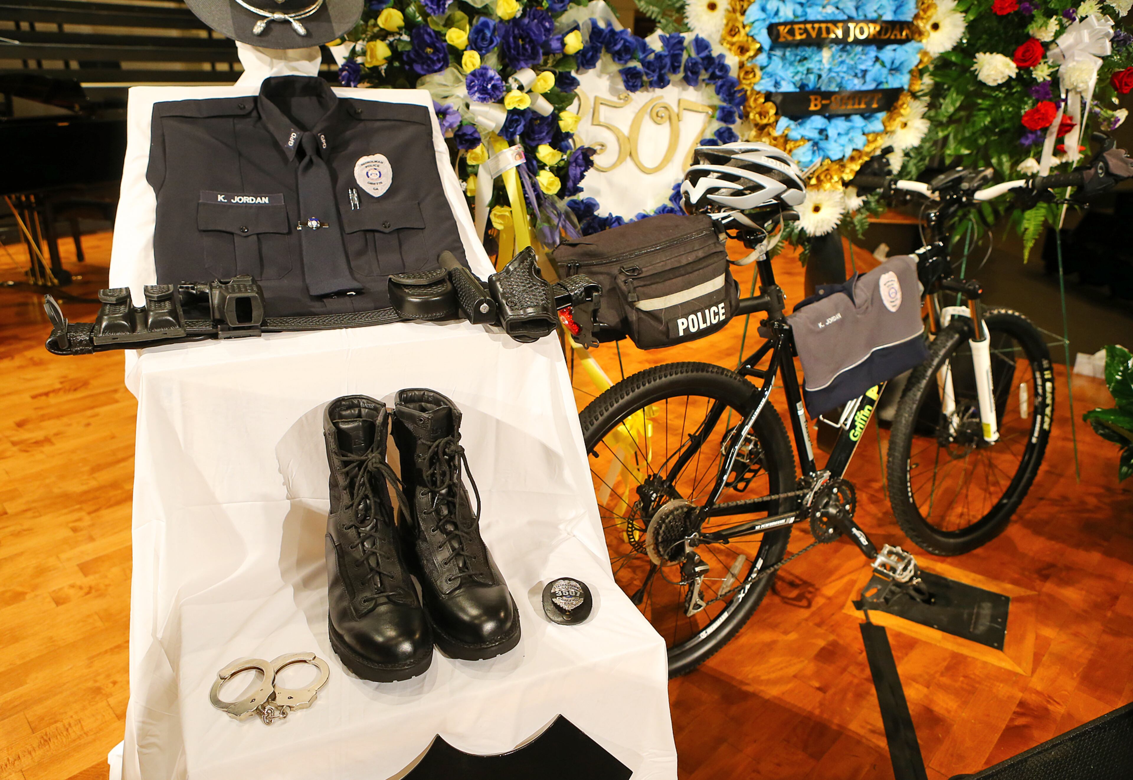 The funeral for Griffin police officer Kevin "Shogun" Dorian Jordan, 43, was held Monday at the Oak Hill Baptist Church in Williamson. Jordan, a four-year veteran of the Griffin police force and father of seven, was shot and killed May 31 while working off-duty at a Waffle House on U.S. 41. Jordan was attempting to remove three drunken and disruptive customers from the restaurant when the shooting occurred. Police said Chantell Mixon, 28, put up a fight in the parking lot while Jordan tried to arrest her. Police said Mixon's boyfriend, 30-year-old Michael Dwayne Bowman, pulled out a gun and shot Jordan at least three times. CURTIS COMPTON / CCOMPTON@AJC.COM