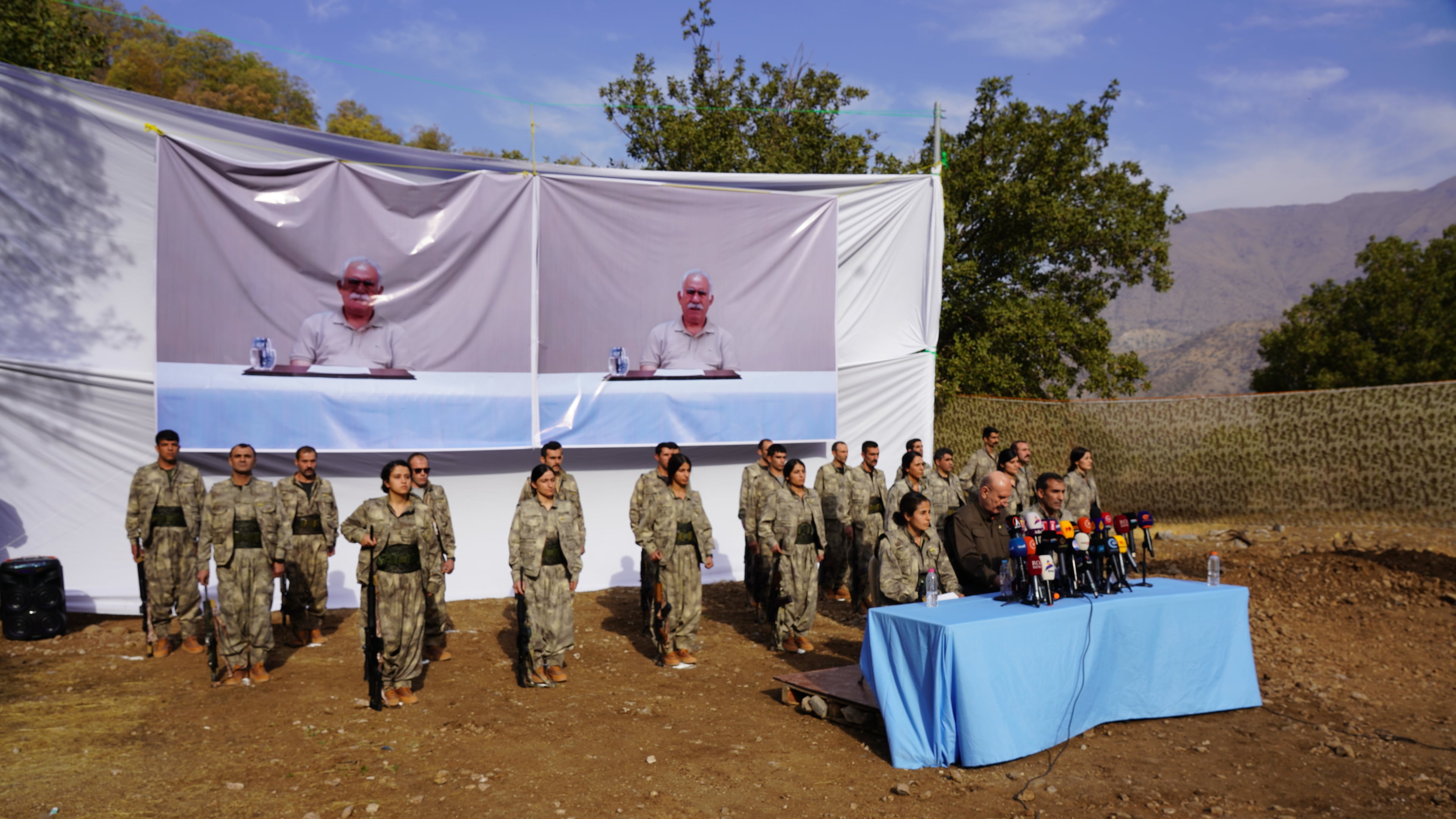 FILE - Kurdistan Workers' Party (PKK) fighters, who reportedly withdrew from Turkey with their weapons, stand to attention during a ceremony in the Qandil area of northern Iraq, щт Oct 26, 2025. (AP Photo/Rashid Yahya, File)