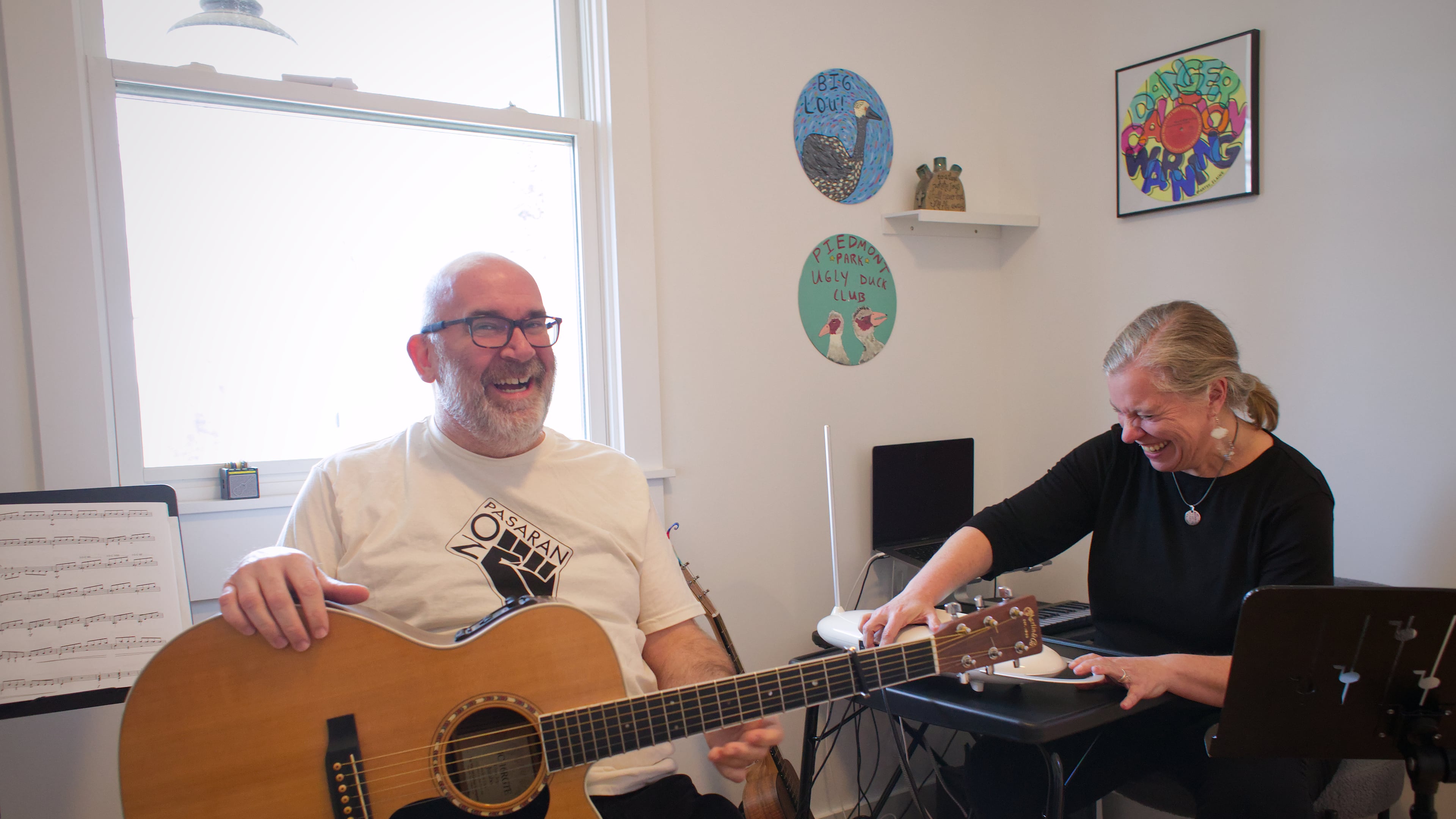 Paul and Melanie Shaw play music together in their Scottdale home. He's a guitarist and drummer. She plays theremin. They perform in the folk-inflected band Acoustic Station. (Courtesy of Dustin Timbrook)
