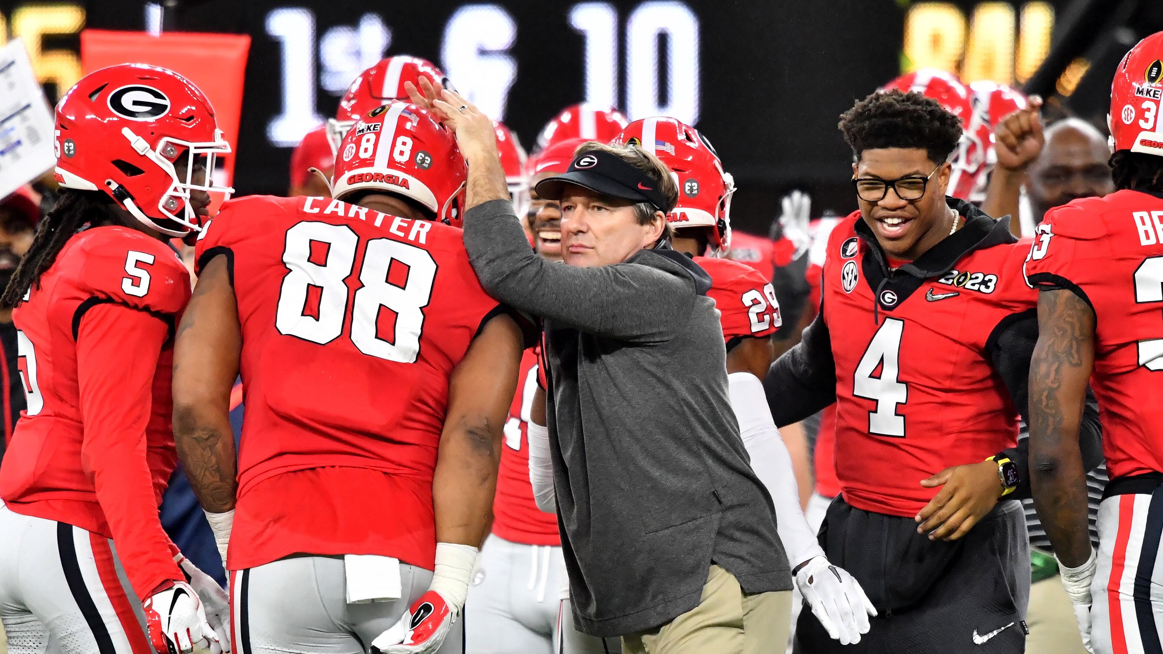 Georgia Bulldogs head coach Kirby Smart congratulates his players as captain and defensive end Nolan Smith (4) reacts during the second half of the College Football Playoff National Championship at SoFi Stadium in Los Angeles on Jan. 9, 2023. Georgia won 65-7 and secured a back-to-back championship. (Hyosub Shin / Hyosub.Shin@ajc.com)