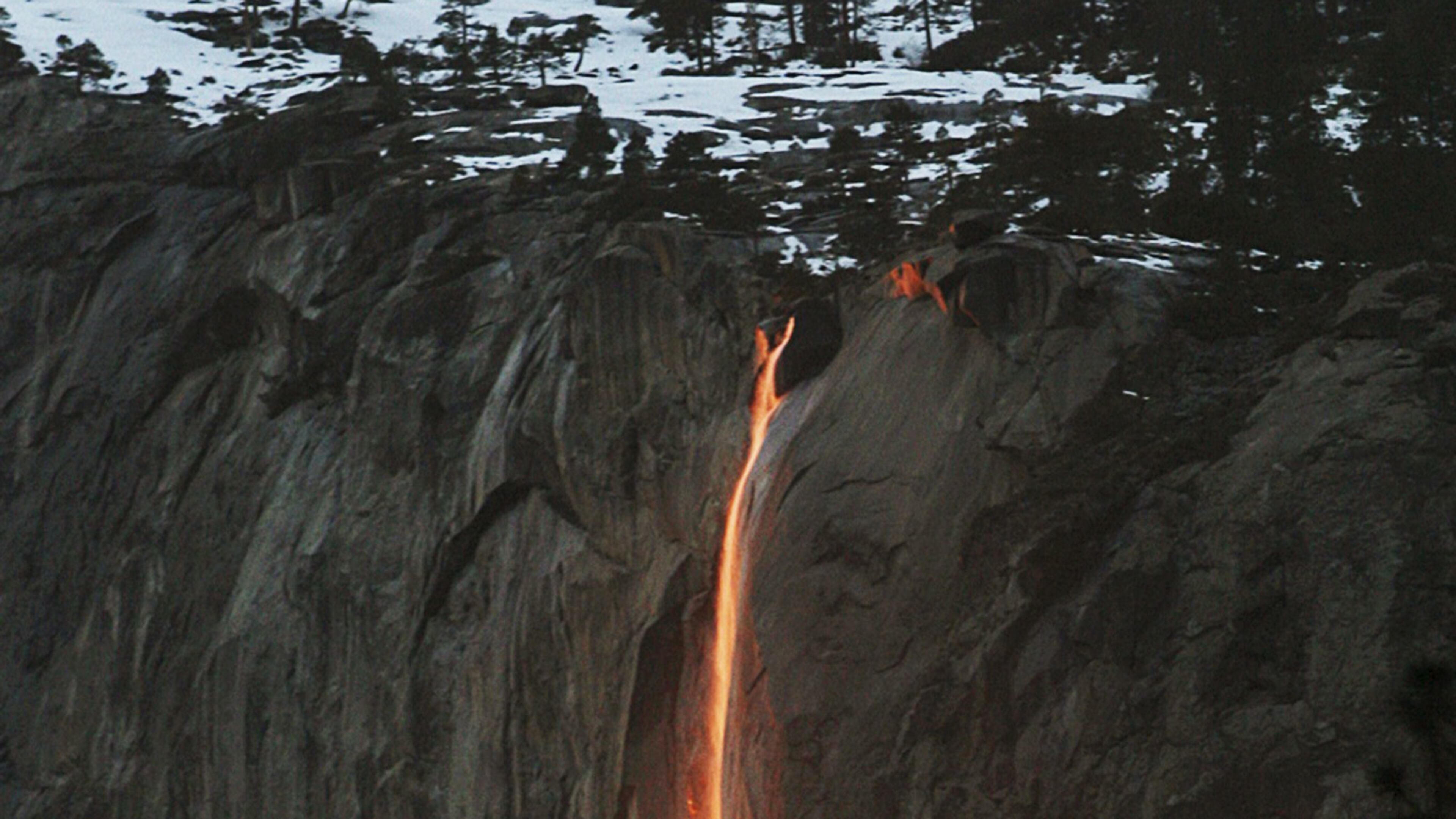 In this Feb. 16, 2010, file photo, a shaft of sunlight creates a glow near Horsetail Fall, in Yosemite National Park, Calif. Mother Nature is again putting on a show at Californiaâs Yosemite National Park, where every February the setting sun draws a narrow sliver on a waterfall to make it glow like a cascade of molten lava. The phenomenon known as "firefall" draws scores of photographers to the spot, which flows down the granite face of the park's famed rock formation, El Capitan. (Eric Paul Zamora/The Fresno Bee via AP, File)