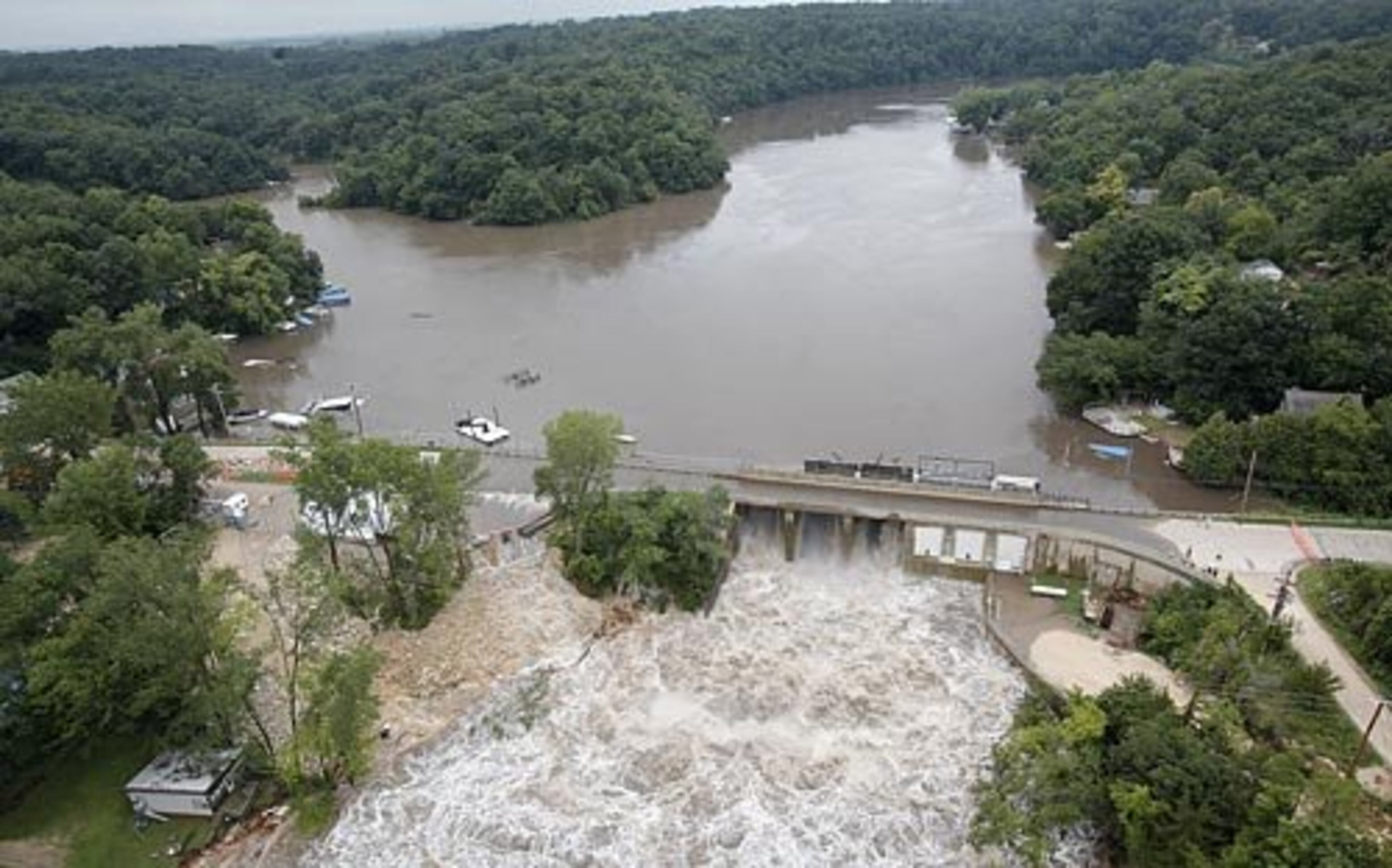 The flooding in Manchester happened after the Lake Delhi dam (above) failed Saturday as rising floodwater from the Maquoketa River ate a 30-foot-wide hole in it. Areas below the eastern Iowa dam, including Hopkinton and Monticello, were evacuated.
