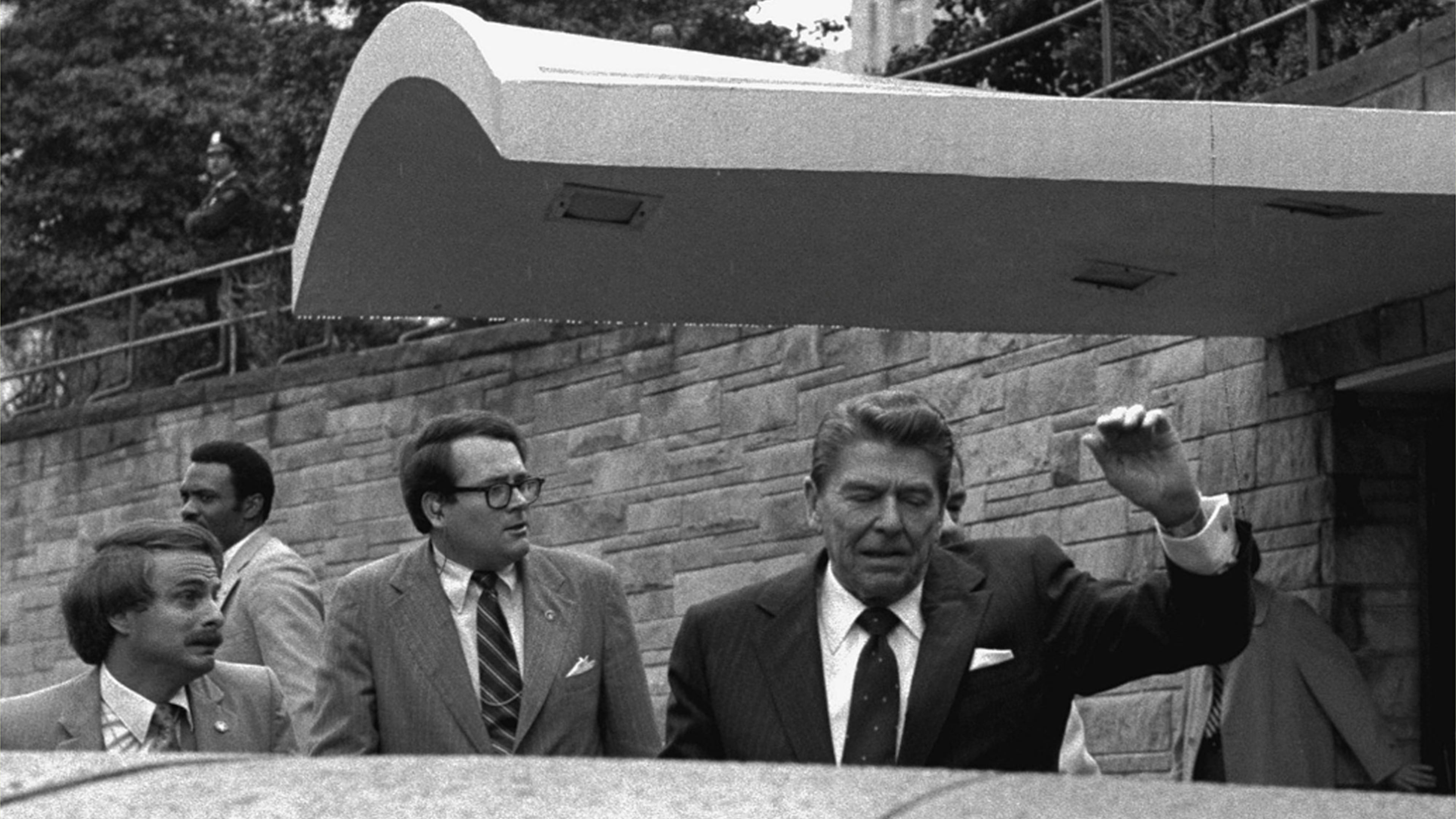 FILE - President Ronald Reagan winces and raises his left arm as he was shot by an assailant as he left a Washington hotel, Monday, March 30, 1981. (AP Photo/Ron Edmonds, File)
