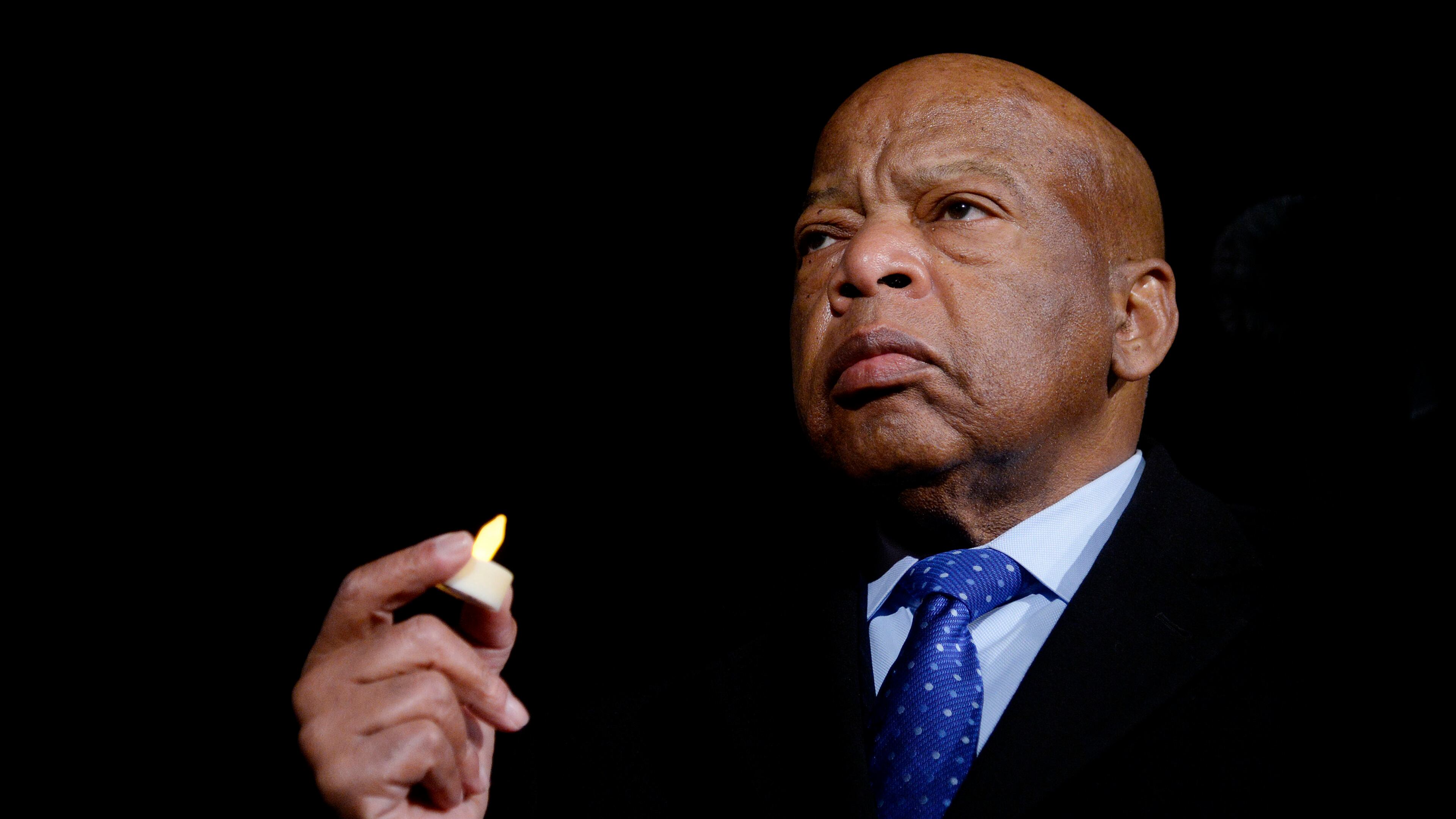 U.S. Rep. John Lewis (D-GA) holds a candle during an event to address President Donald Trump's executive orders on January 30, 2017, in front of the Supreme Court in Washington, D.C. (Olivier Douliery/Abaca Press/TNS)