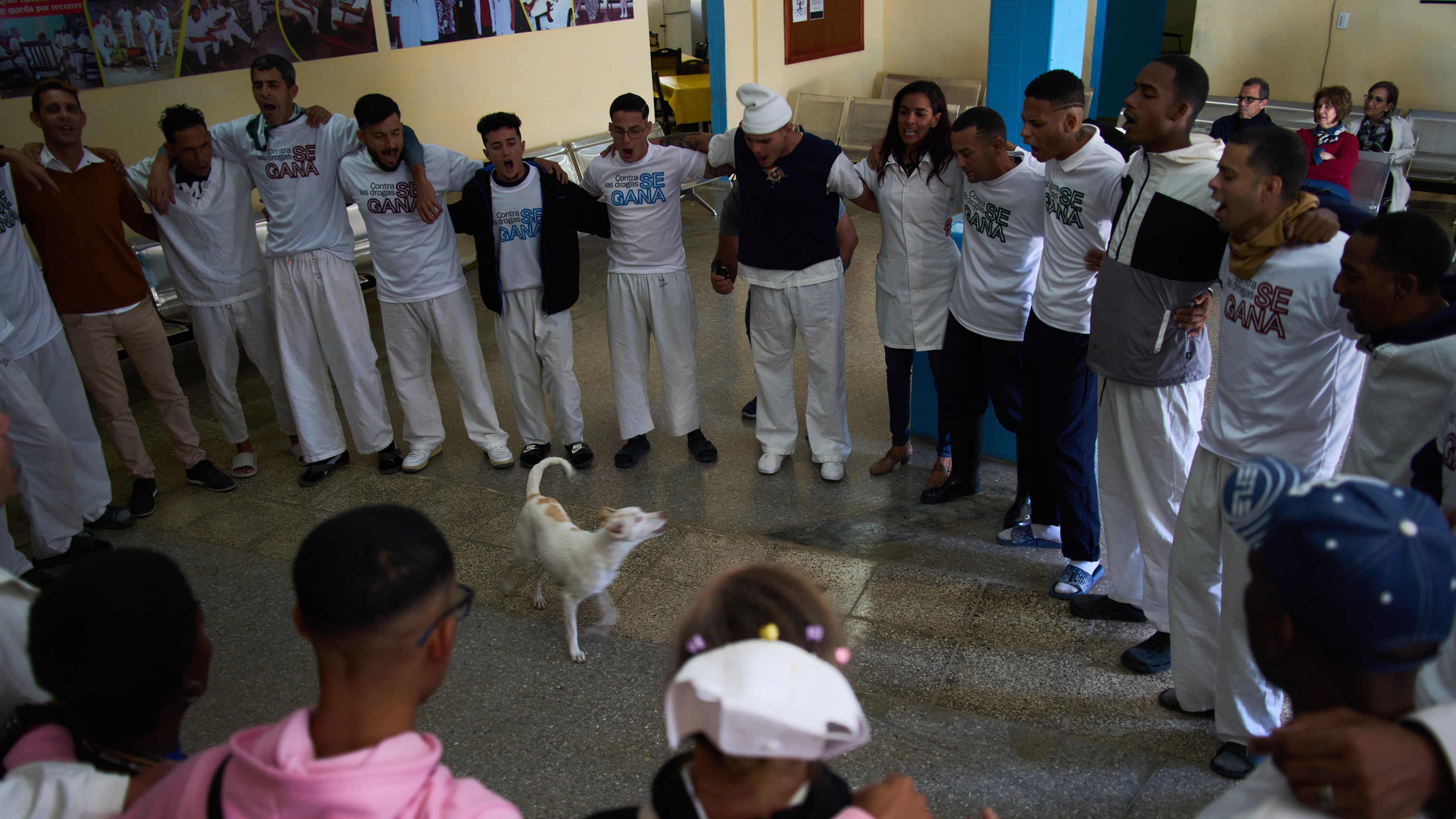 People undergoing rehabilitation hug in a circle at a psychiatric hospital in Havana, Cuba, Wednesday, Feb. 25, 2026. (AP Photo/Ramon Espinosa)
