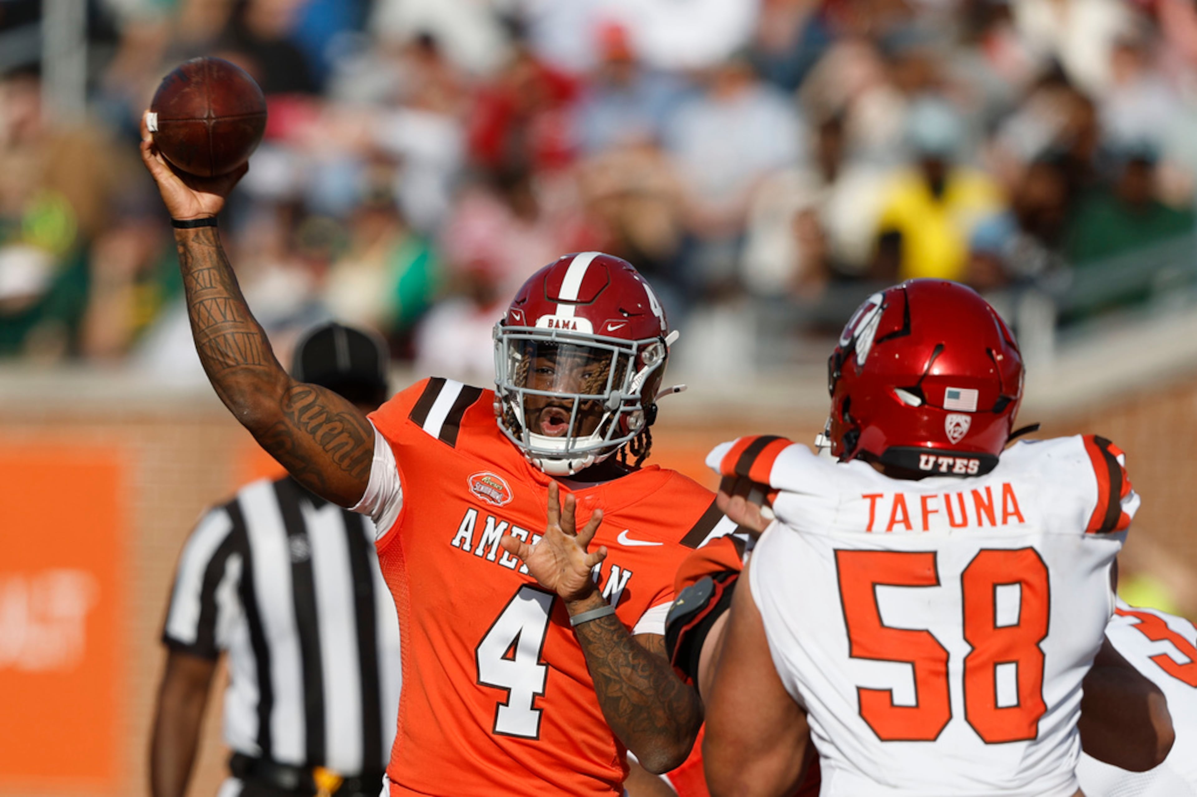 American team quarterback Jalen Milroe (4), of Alabama, looks to throw a pass as National team defensive lineman Junior Tafuna (58), of Utah, applies pressure during the second half of the Senior Bowl NCAA college football game, Saturday, Feb. 1, 2025, in Mobile, Ala. (AP Photo/Butch Dill)