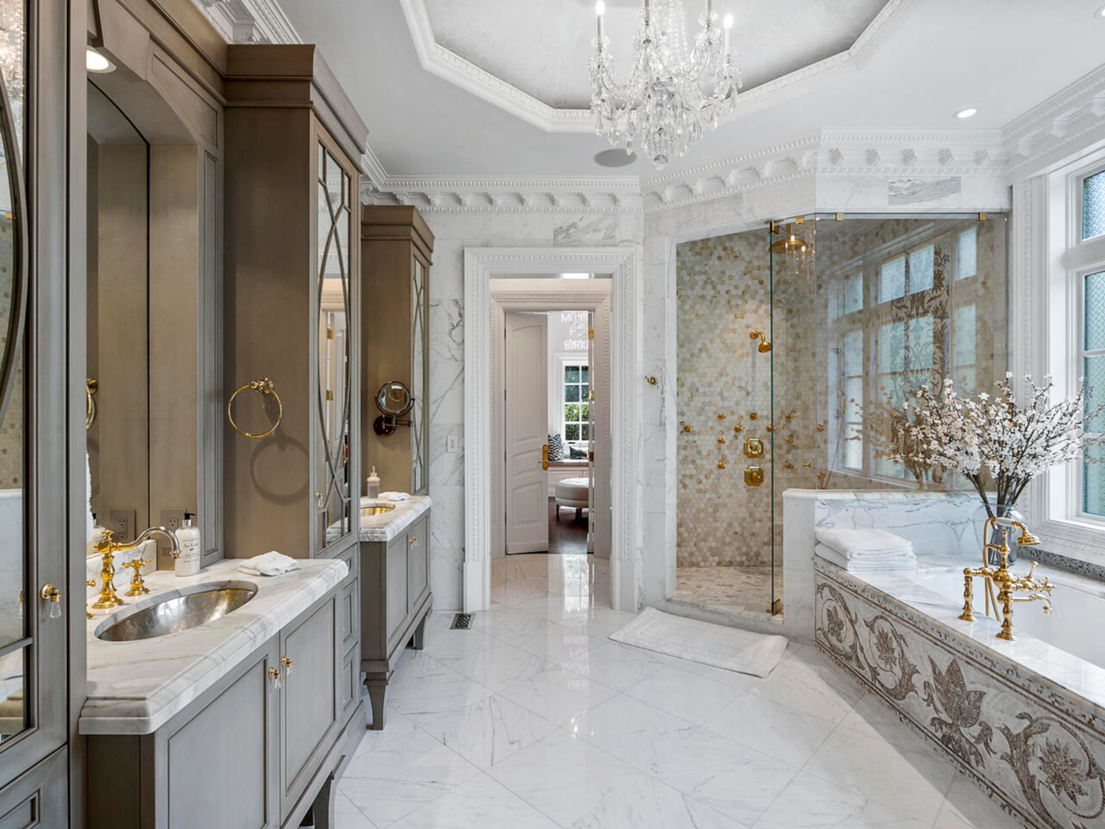 The owners’ private bathroom features a marble stand-alone spa tub and an oversized walk-in rain shower with mosaic and marble. Double vanities, marble flooring and walls are highlighted by the octagonal ceiling and crystal chandelier. Text by Elizabeth Manderson and Julie Pedersen/Photo by Ilya Zobanov, Gold Lens Media.