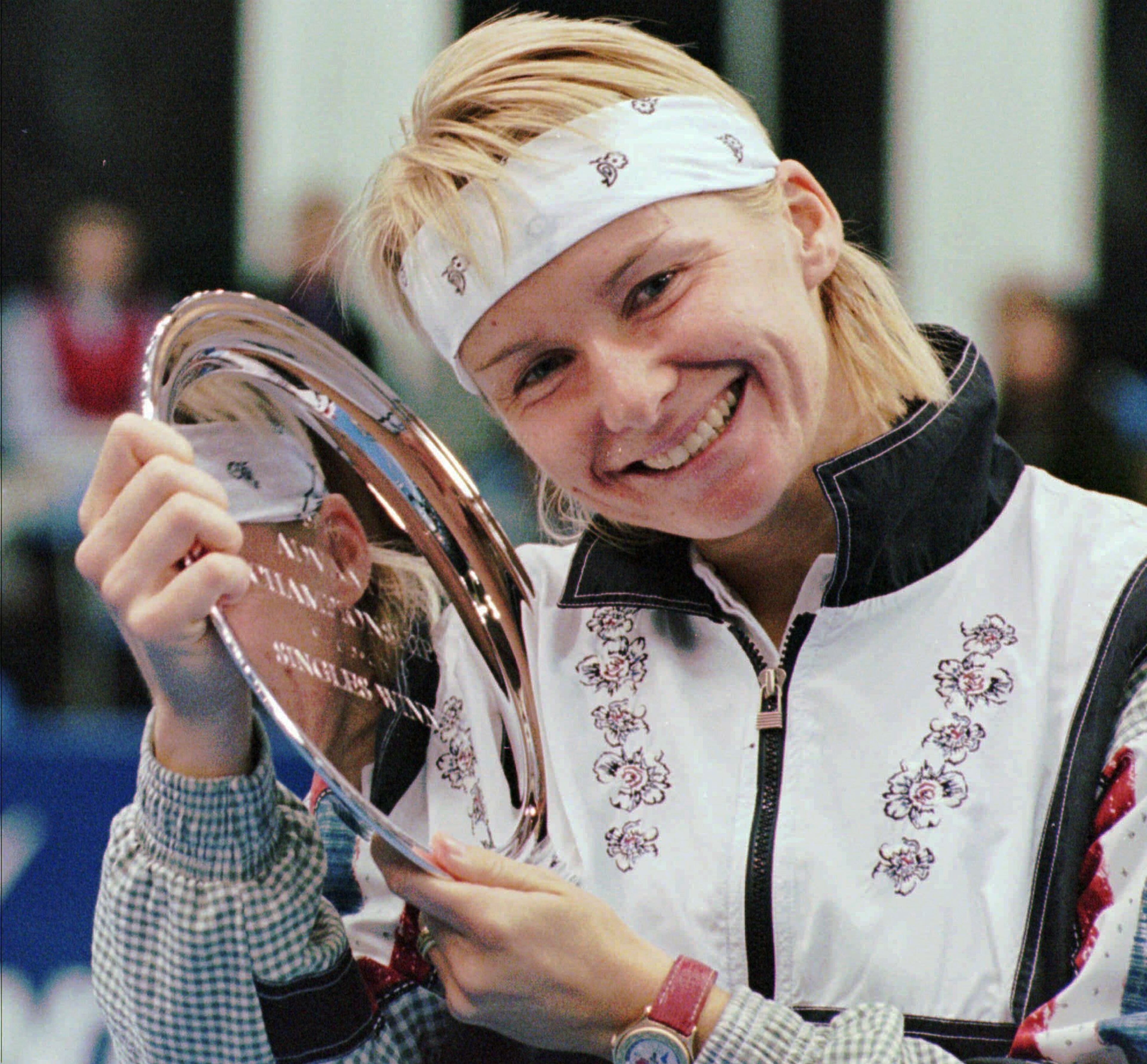 FILE - In this Nov. 17, 1996 file photo, Jana Novotna, of the Czech Republic, is all smiles after taking home a $79,000 check from the Advanta Tennis Championship in Villanova, Pa. The WTA says the 1998 Wimbledon champion Jana Novotna of the Czech Republic has died. In a Monday, Nov. 20, 2017 statement, the WTA say Novotna died after battling a cancer on Sunday, Nov. 19. She was 49.(AP Photo/Jim Graham, File)