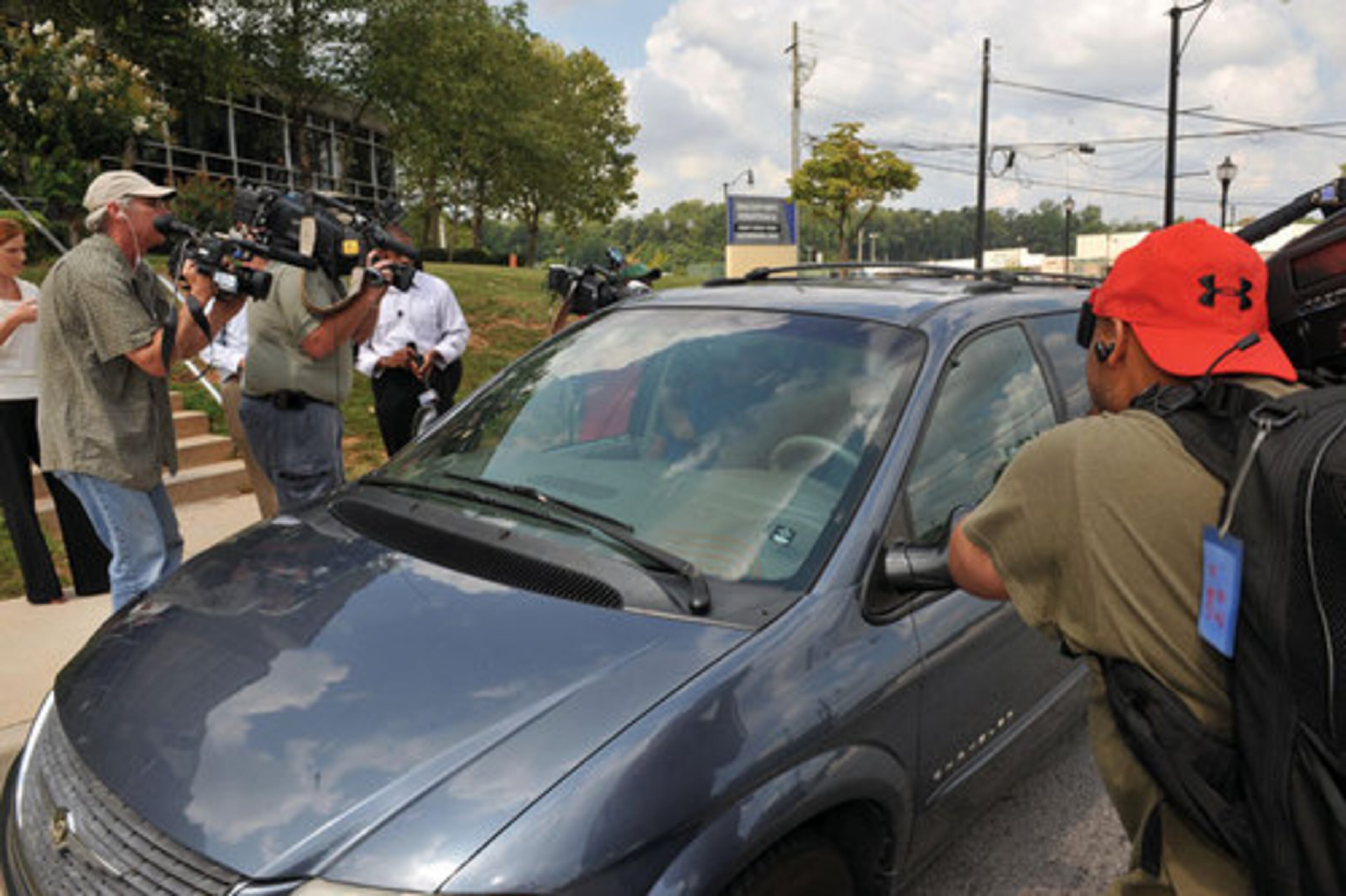 Sneiderman was whisked to into a minivan driven by defense attorney Doug Chalmers that was waiting on Camp Road just outside the jail.