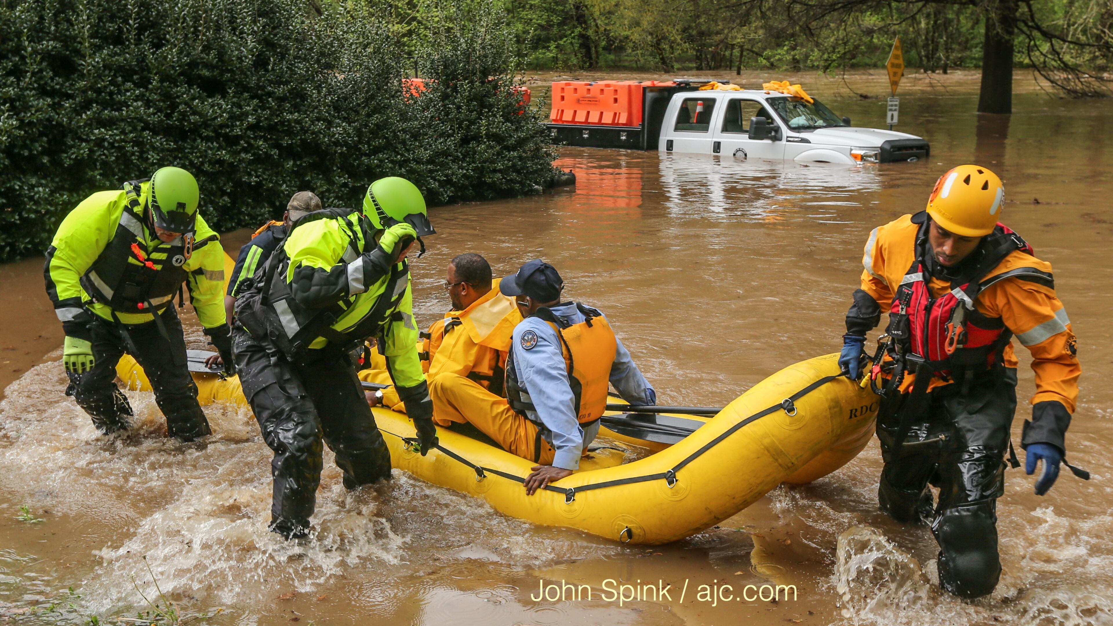 Atlanta watershed employees were rescued from the flooded Peachtree Creek near Woodward Way.