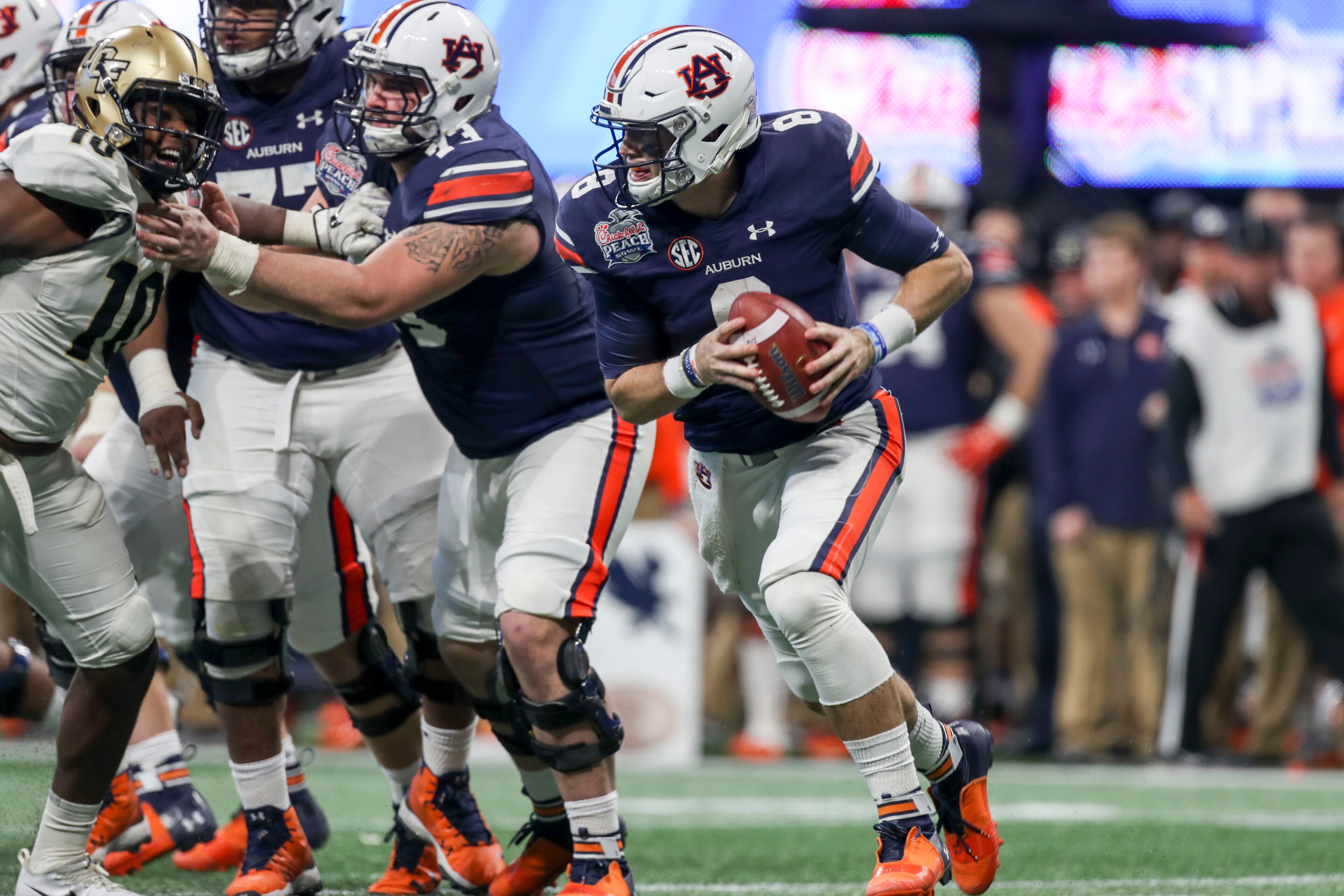 01/01/2018 -- Atlanta, GA, - Auburn Tigers quarterback Jarrett Stidham (8) runs the ball during the second half of the Chick-fil-a Peach Bowl at Mercedes-Benz Stadium, Monday, January 1, 2018. The UCF Knights beat the Auburn Tigers, 34-27. ALYSSA POINTER/ALYSSA.POINTER@AJC.COM