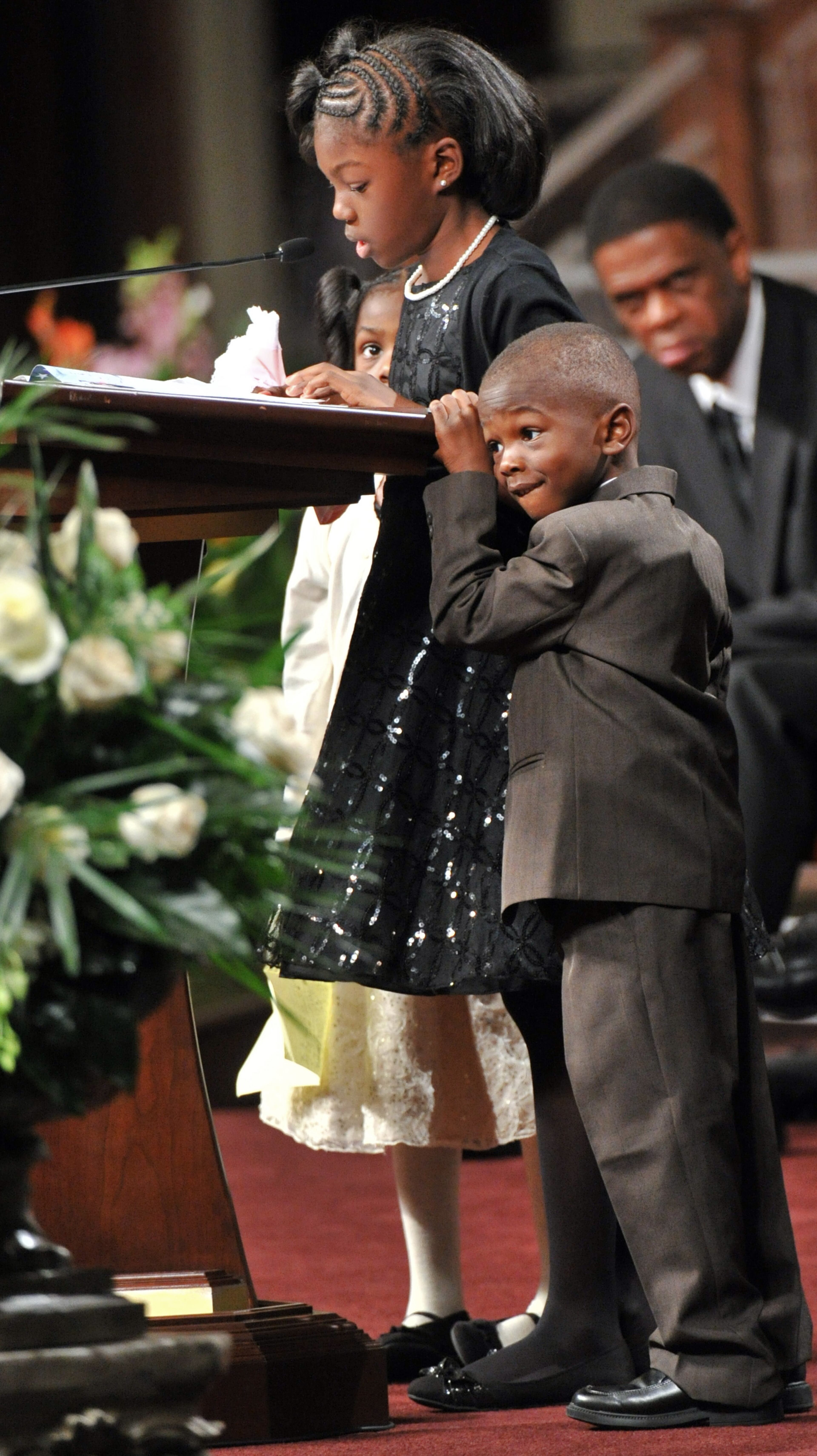 APD Officer Shawn Smiley's children Victoria Smiley (center at podium) speaks as Elizabeth Smiley (background), and William Smiley (foreground) stand by their sister during APD Officer Shawn Smiley's funeral at First Baptist Church of Atlanta on Saturday, November 10, 2012. APD Officer Shawn Smiley was in the passenger seat last weekend when an APD helicopter searching for a missing 9-year-old boy crashed in Atlanta. HYOSUB SHIN / HSHIN@AJC.COM