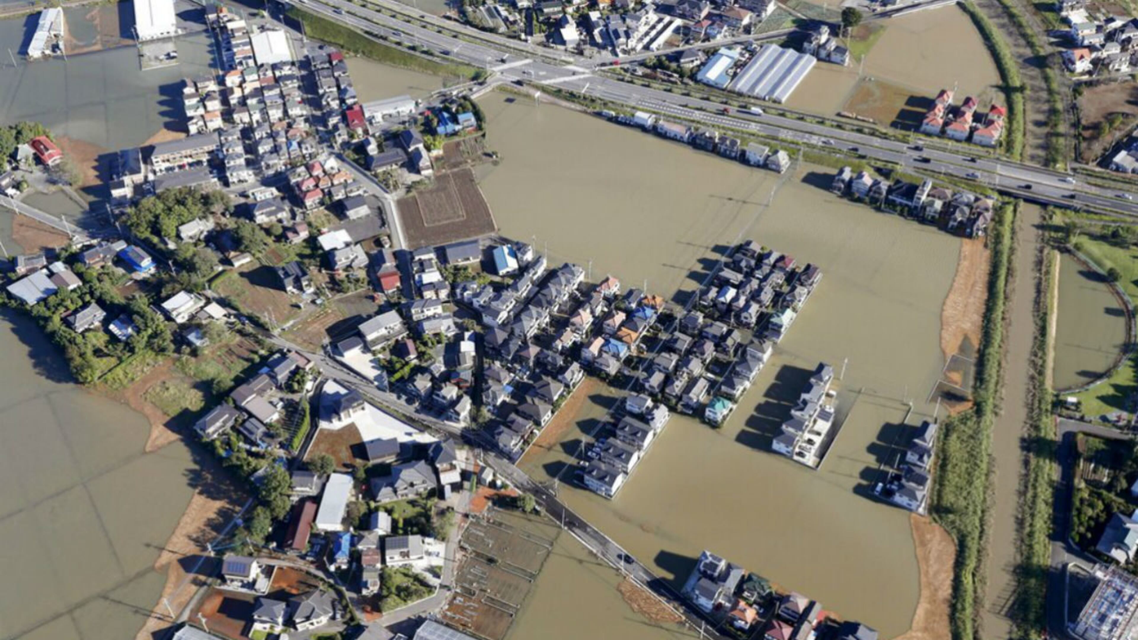 Houses are submerged in muddy waters as Typhoon Hagibis hit the area, in Kawagoe, north of Tokyo, Sunday, Oct. 13, 2019.