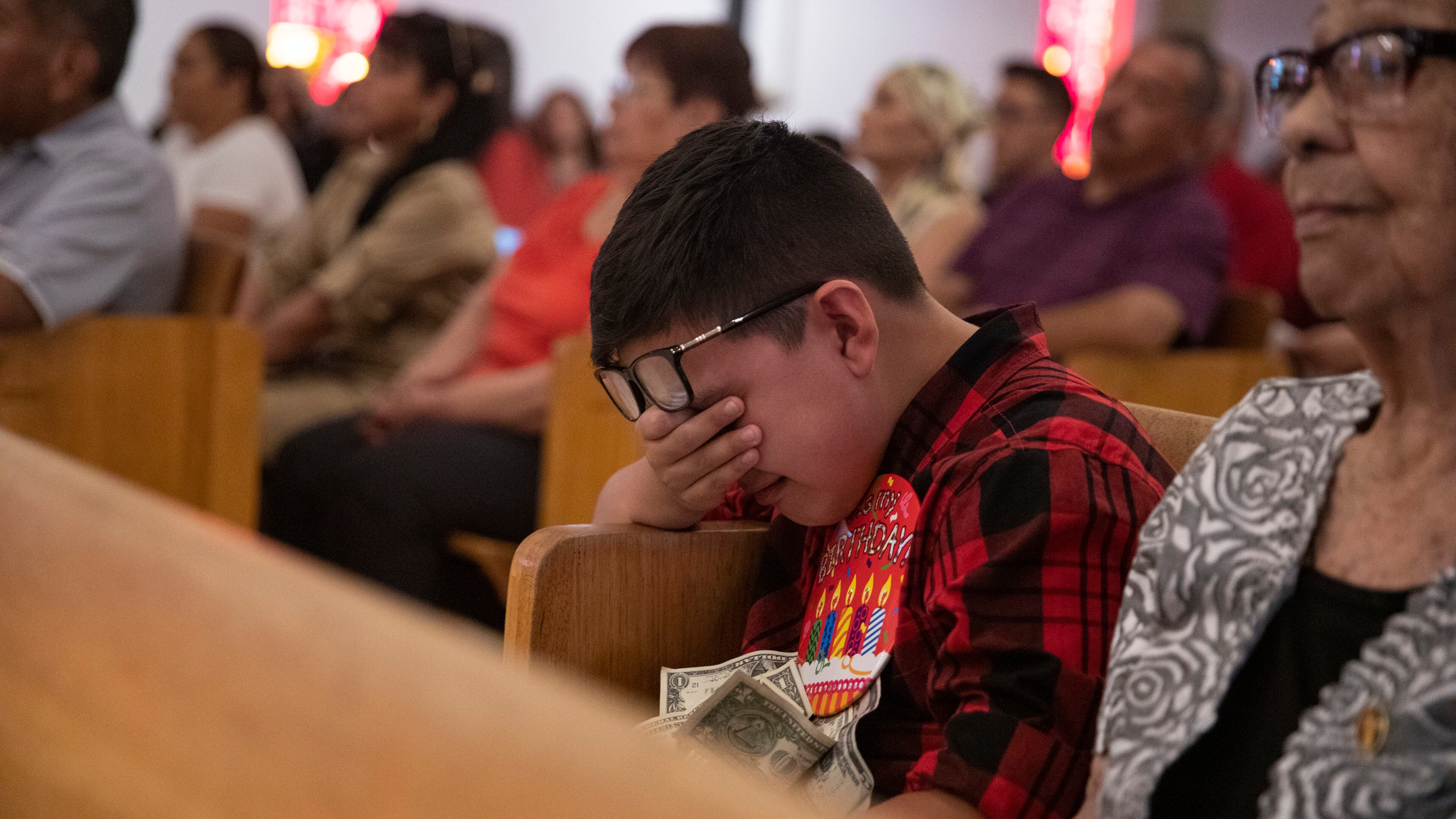 Thomas Ledesma cries during a Mass honoring the victims of the El Paso mass shooting, at El Buen Pastor Mission on the outskirts of El Paso, Texas, on Sunday, Aug. 11, 2019.