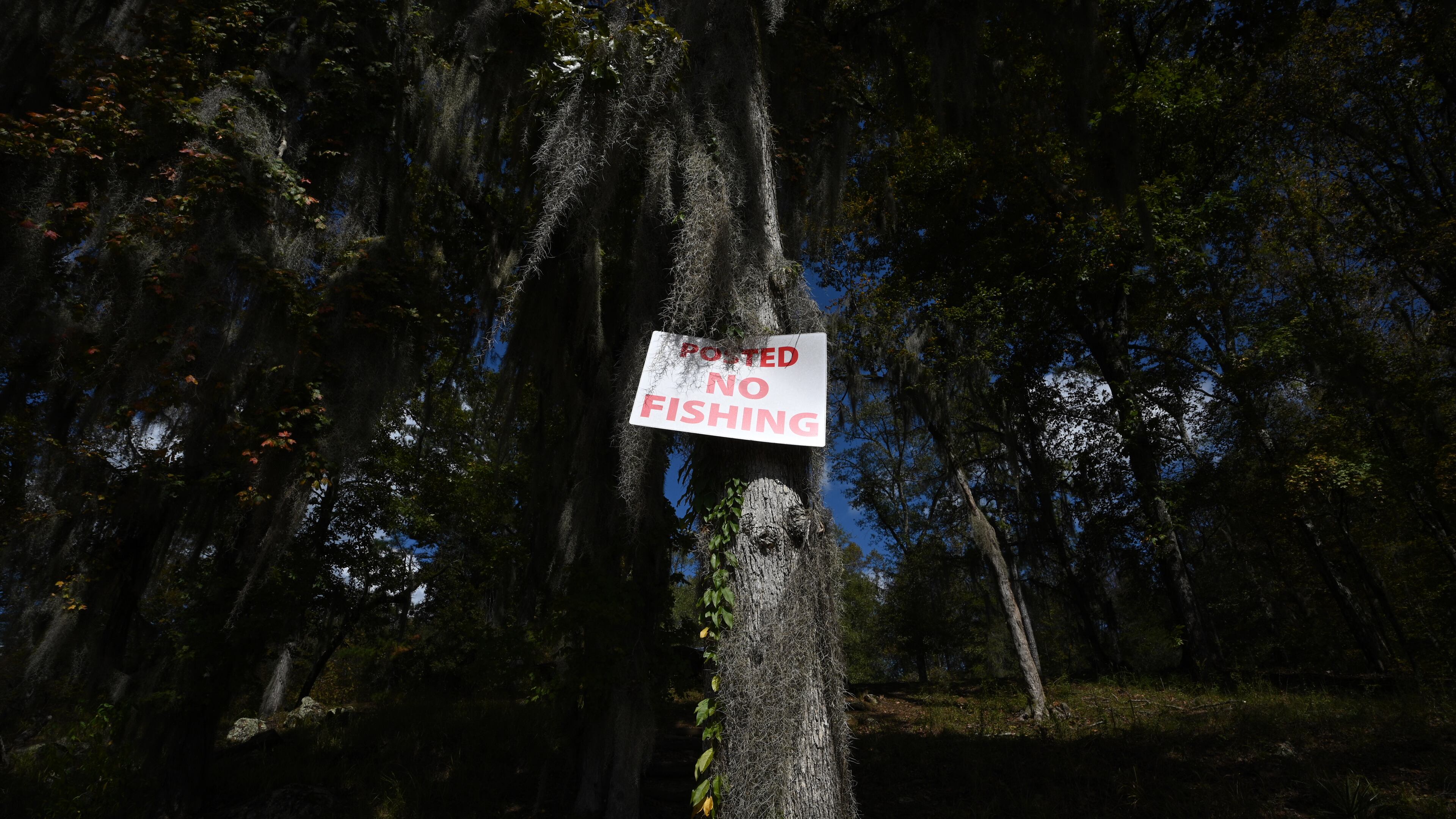 “No Fishing” sign is posted on the private property where fisherman can access to Yellow Jacket Shoals in the Flint River, Thursday, October 19, 2023, in Thomaston. A legal battle over property rights and fishing on the Flint River could have implications for public access to waterways across the state. Recently, two property owners directly across from each other on the Flint River in Upson County and Talbot County, about two hours south of Atlanta, have sued the state to block the public from fishing the shoals that lie between them. (Hyosub Shin / Hyosub.Shin@ajc.com)