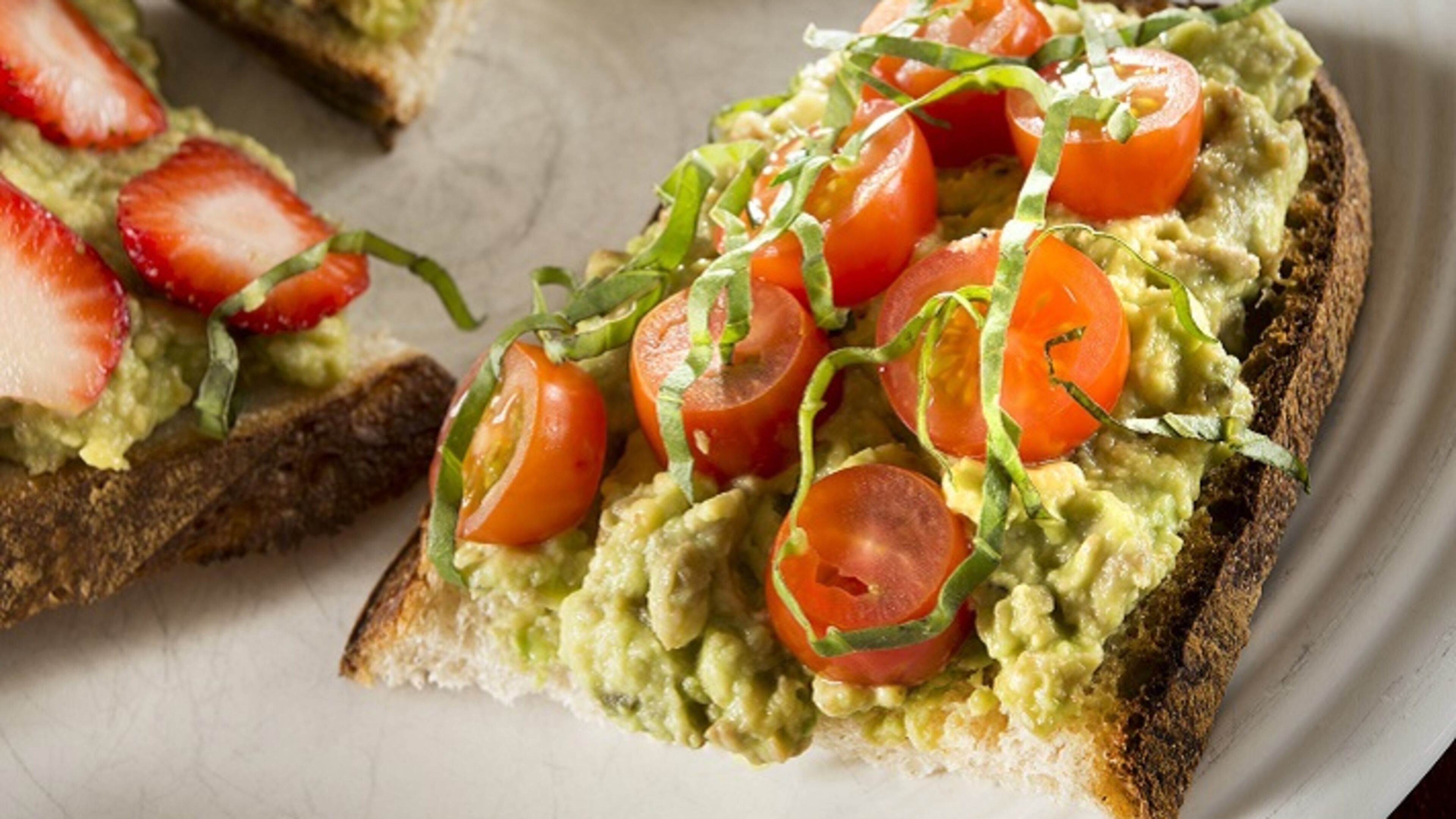 Avocado toast with cherry tomatoes and basil. (Tammy Ljungblad/Kansas City Star/TNS)