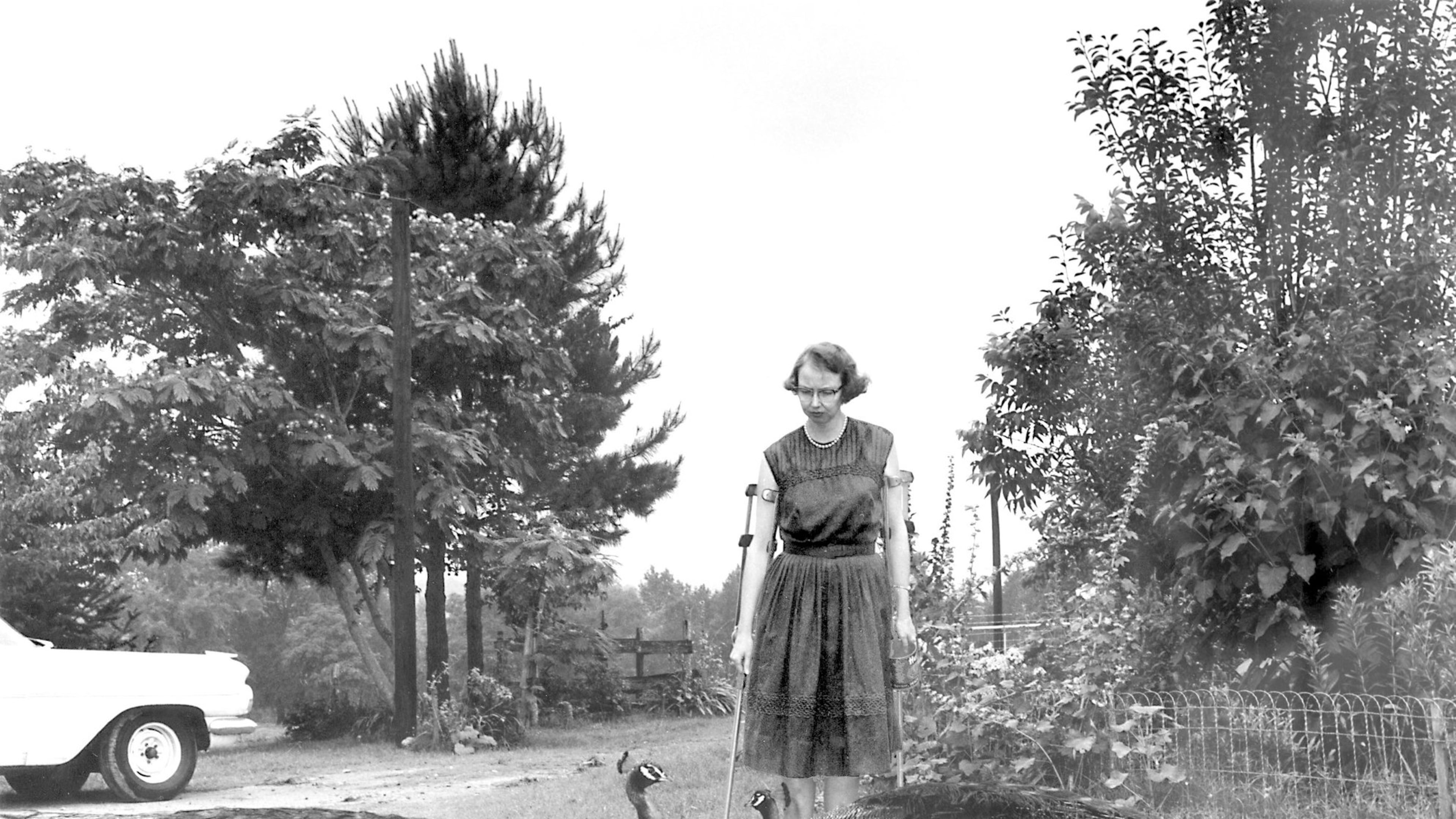 This 1962 photo shows author Flannery O’Connor in the driveway at Andalusia outside of Milledgeville. The author spent the last 13 years of her life on her family's middle Georgia dairy farm, completing her best-known works, including “A Good Man Is Hard To Find.” A new book, “Flannery and Regina: The Andalusia Chronicles,” explores her relationship with her mother there. (Joe McTyre /AJC)