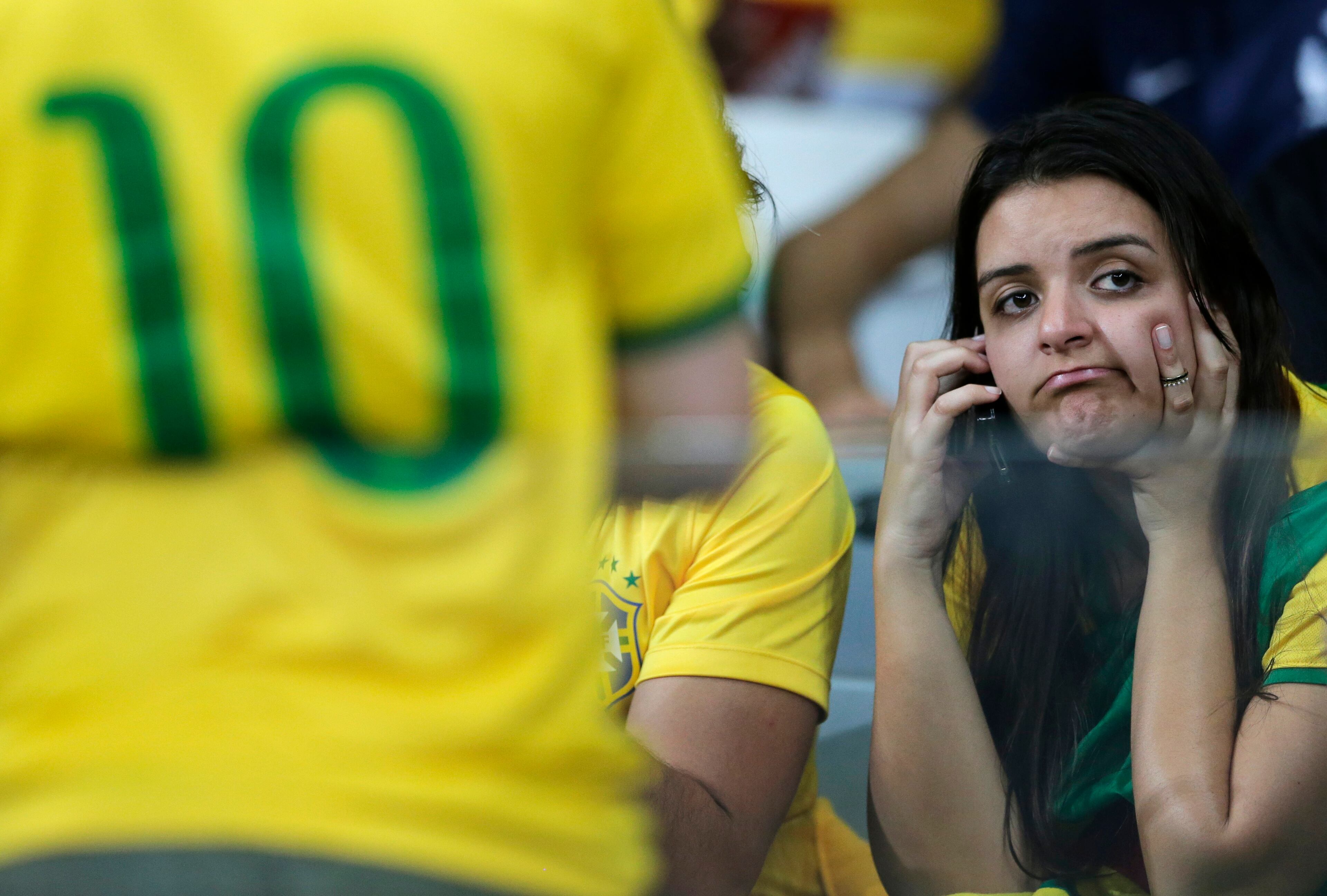 A Brazil supporter reacts during the World Cup semifinal soccer match between Brazil and Germany at the Mineirao Stadium in Belo Horizonte, Brazil, Tuesday, July 8, 2014. (AP Photo/Matthias Schrader)