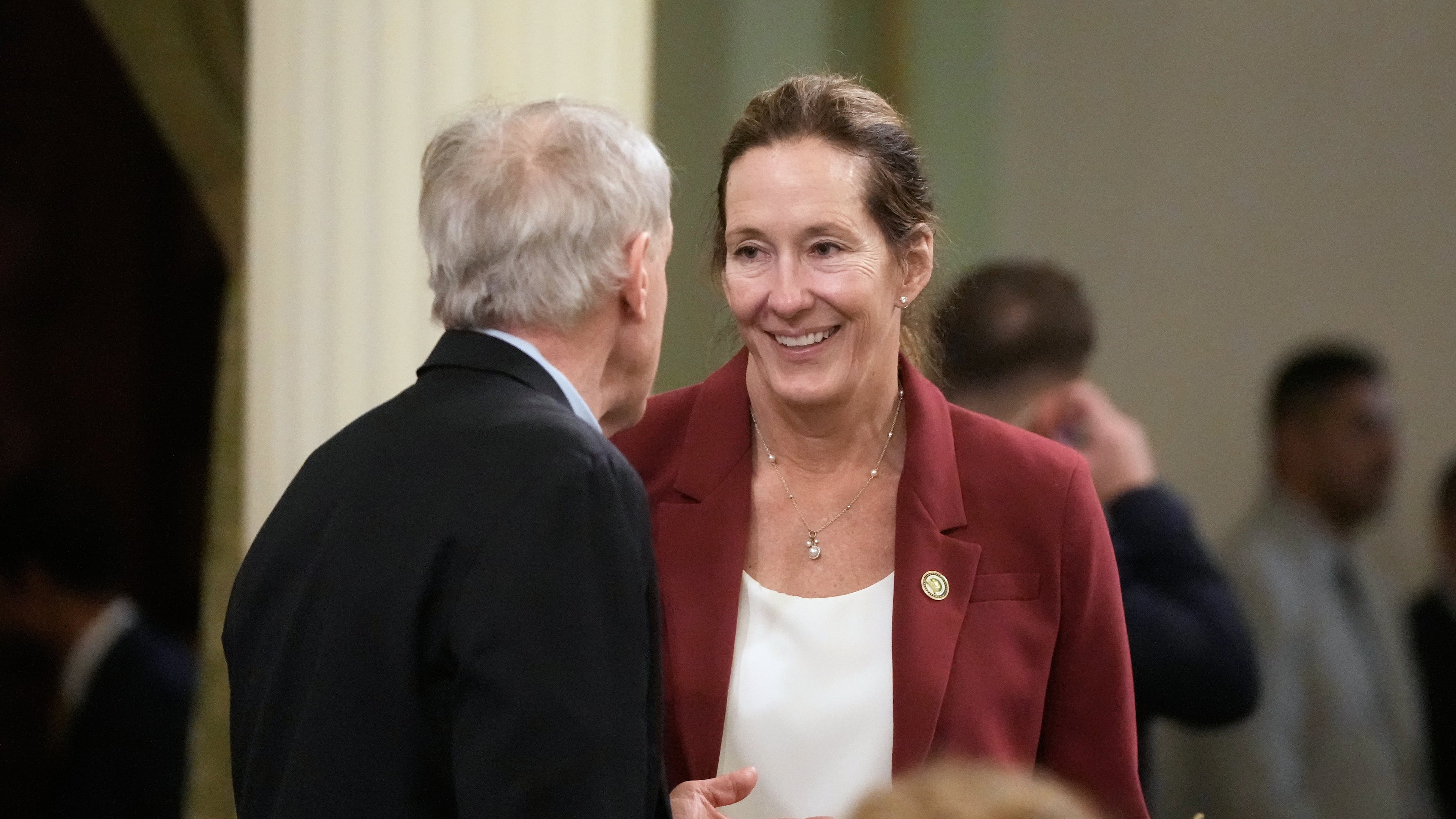 Assemblymember Jacqui Irwin, right, talks with Assemblymember Steve Bennett during an Assembly session at the Capitol, Monday, Aug. 31, 2026, in Sacramento, Calif. (AP Photo/Jeff Chiu)