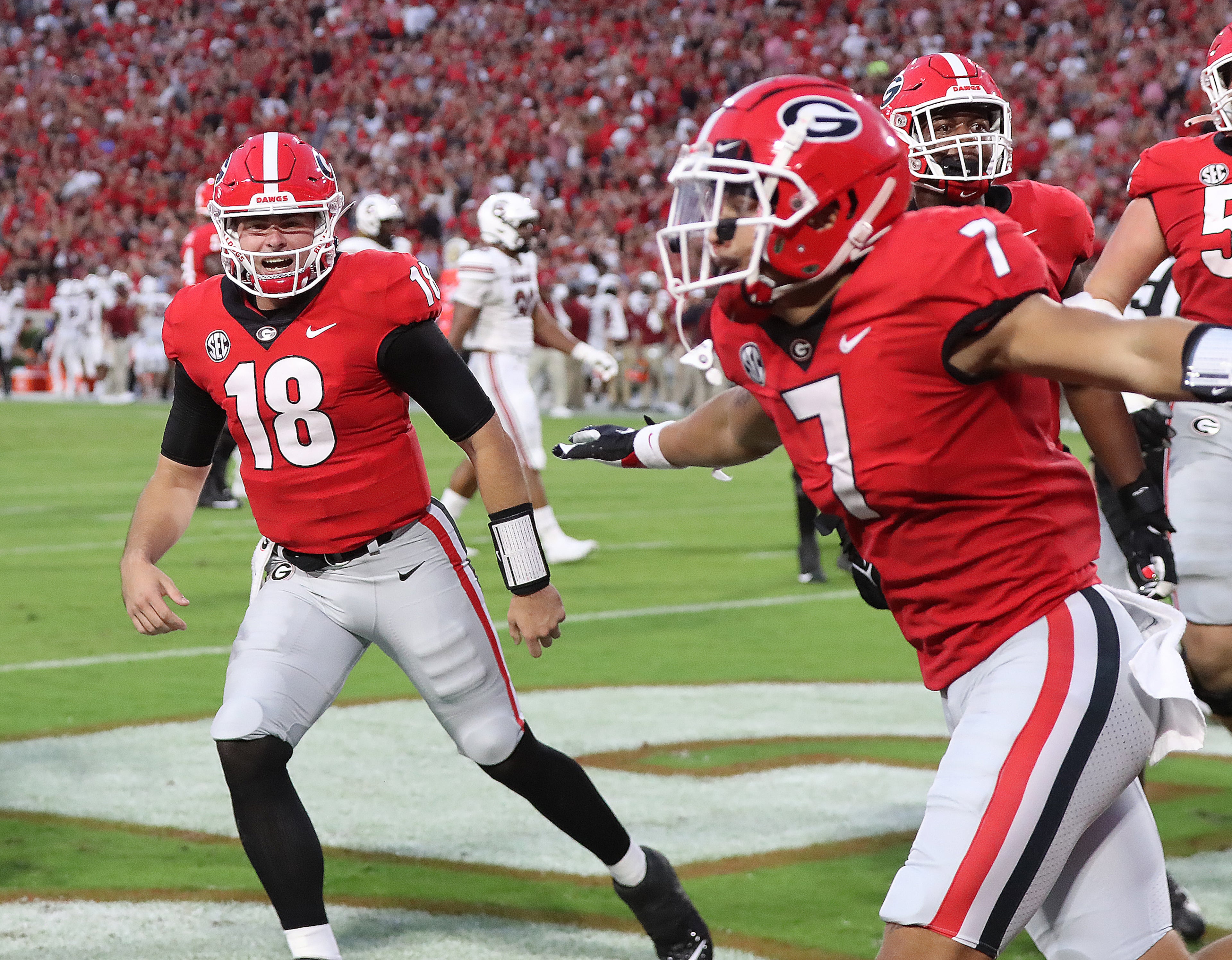 Georgia quarterback JT Daneils (left) and wide receiver Jermaine Burton (right) celebrate hooking up for a 43-yard touchdown reception for a 14-3 lead over South Carolina during the first quarter in a NCAA college football game on Saturday, Sept 18, 2021, in Athens. “Curtis Compton / Curtis.Compton@ajc.com”
