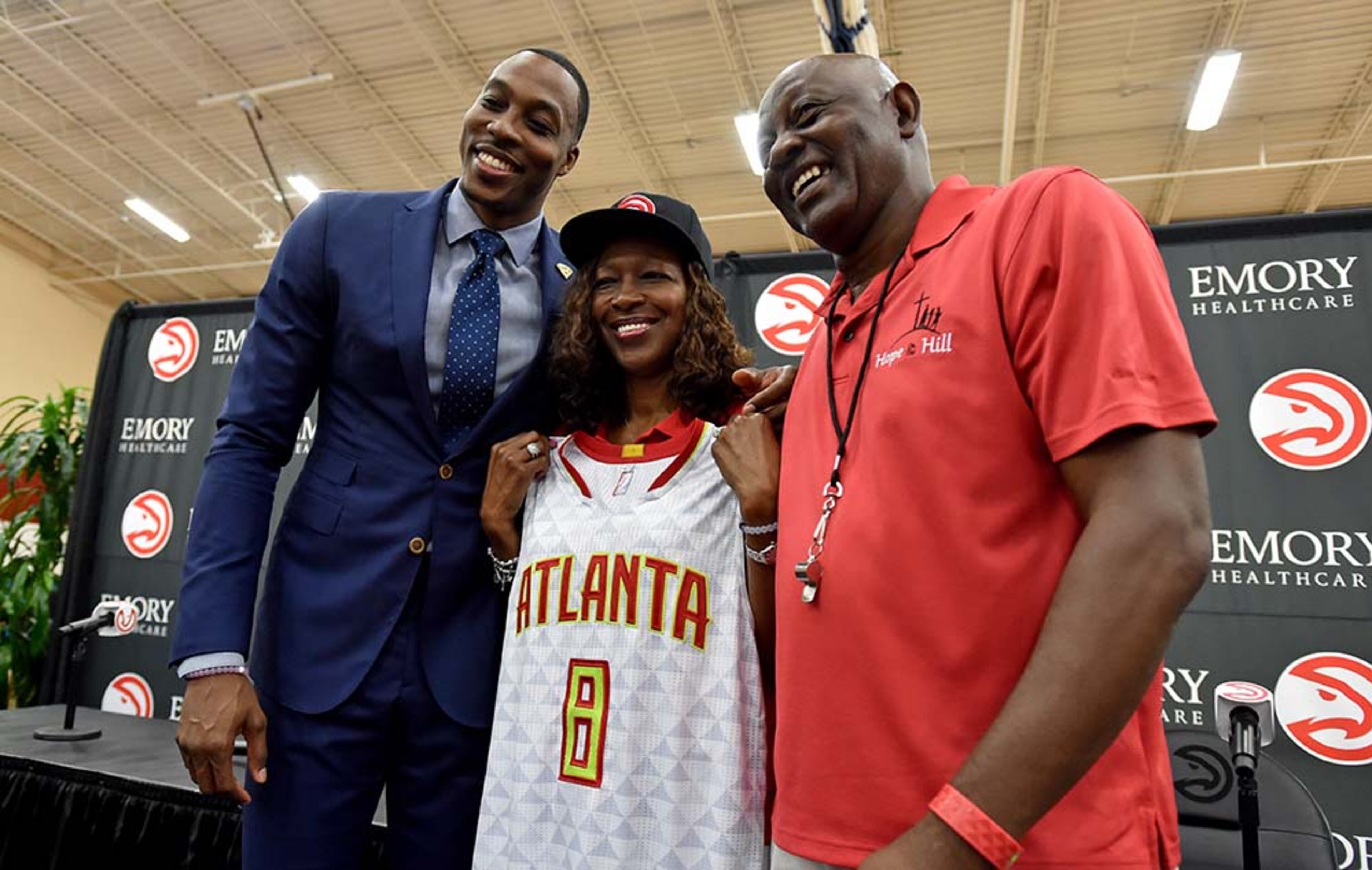 Dwight Howard stops to take photos with his parents Sheryl (center) and Dwight Howard, following press conference announcing his signing as a member of the Atlanta Hawks.