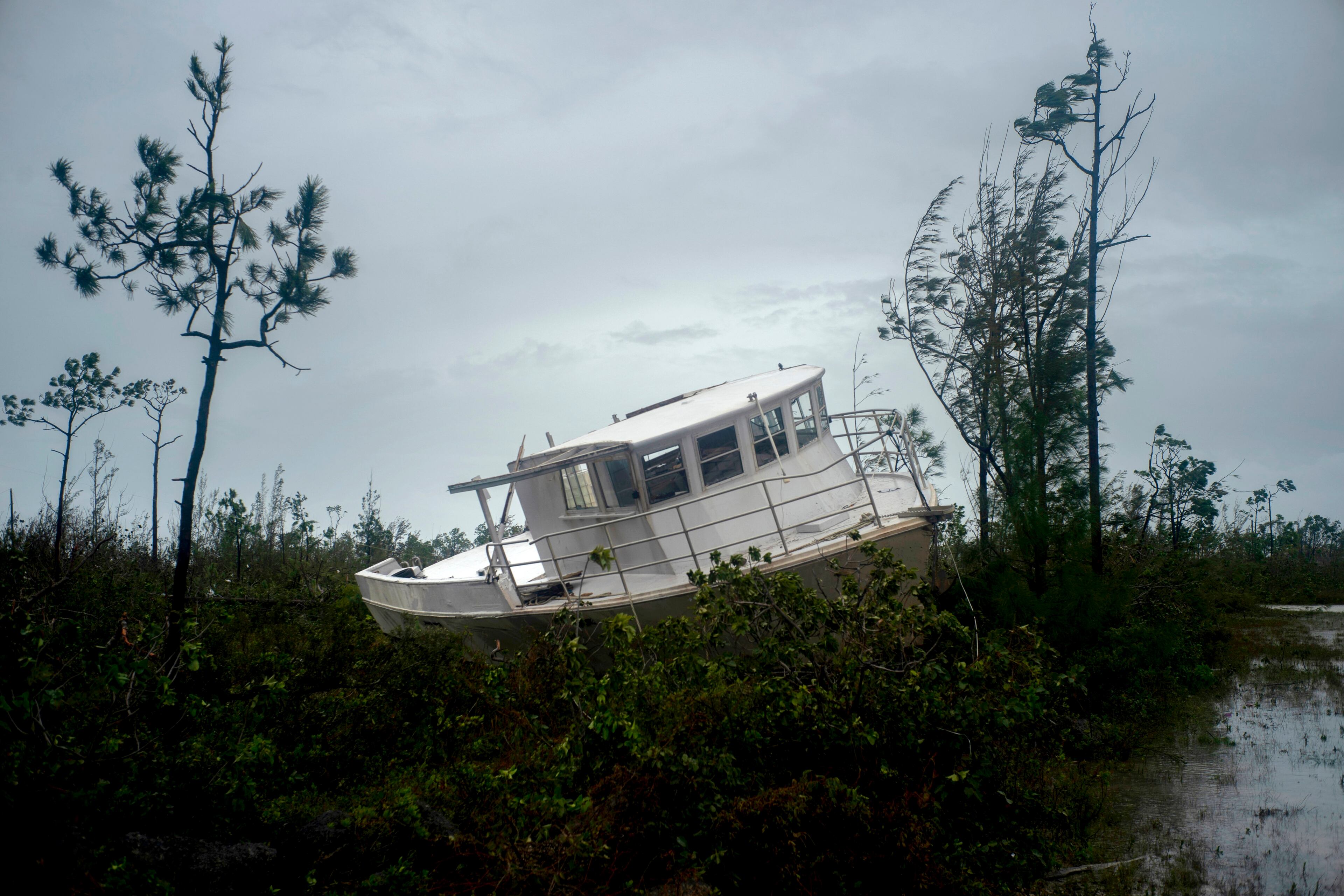A boat thrown onshore by the Hurricane Dorian lays stranded next to a highway near Freeport, Grand Bahama, Bahamas, Tuesday Sept. 3, 2019. Relief officials reported scenes of utter ruin in parts of the Bahamas and rushed to deal with an unfolding humanitarian crisis in the wake of Hurricane Dorian, the most powerful storm on record ever to hit the islands. (AP Photo/Ramon Espinosa)