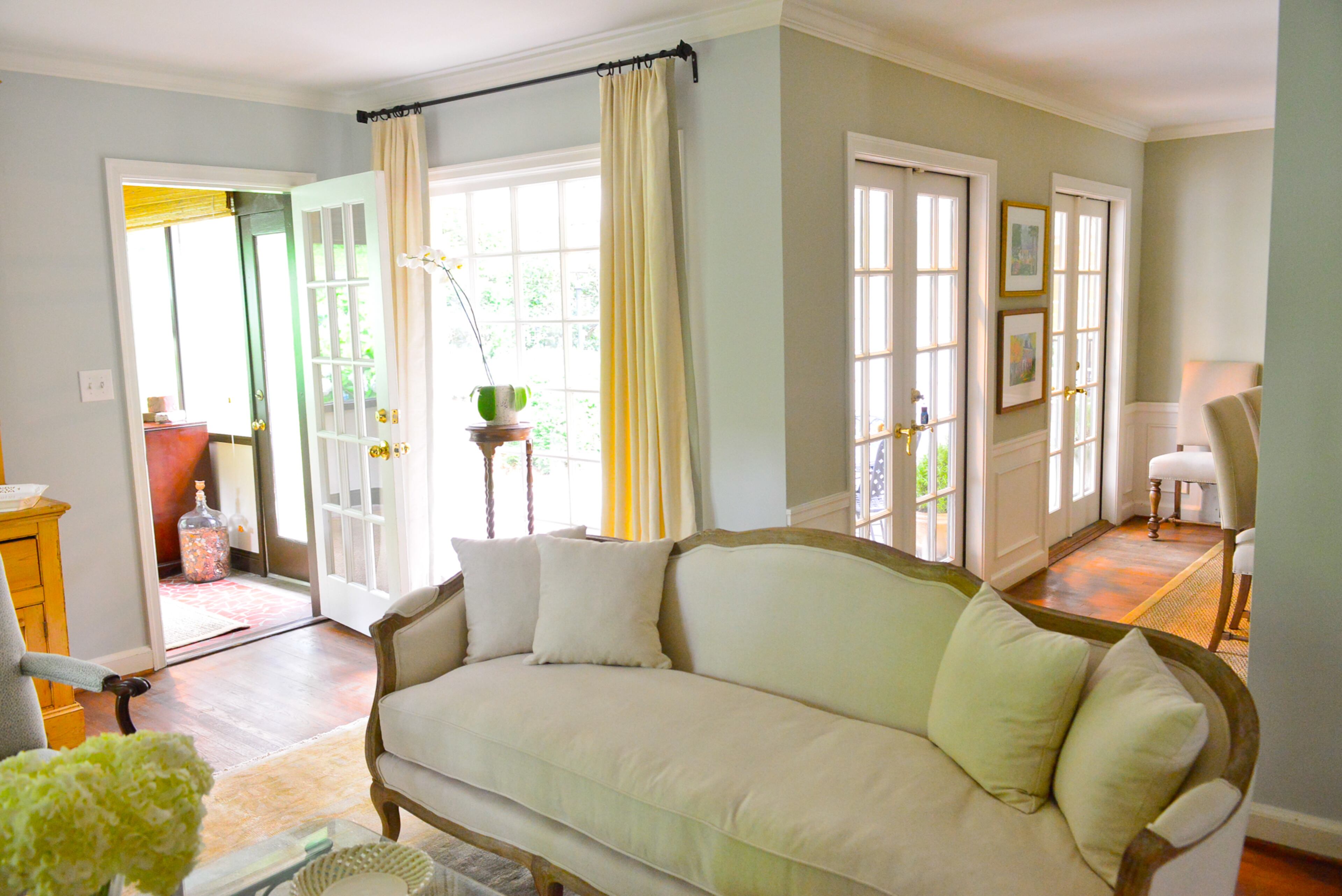 The couple's favorite features in the home are the abundant windows and French doors, which bring in natural light and offers different views of the gardens and backyard. The curved sofa is from Ballad Designs.