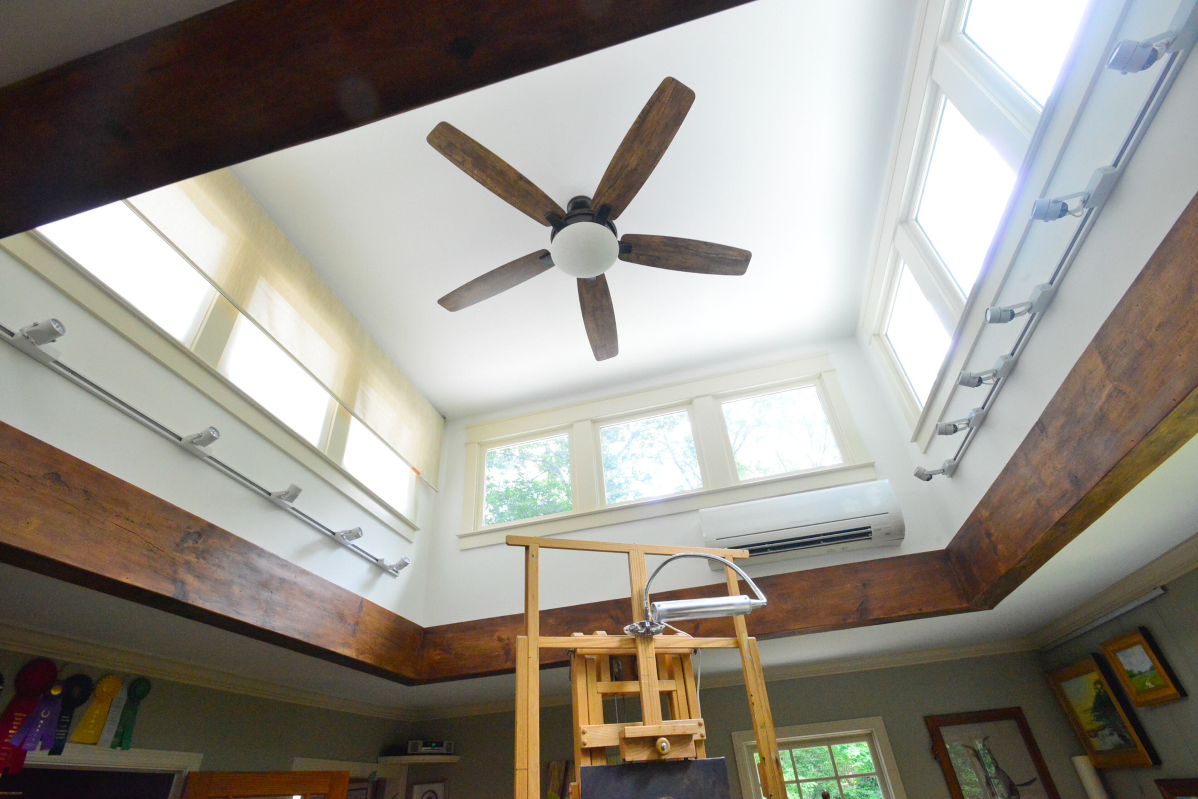 Originally the ceiling in Lisa Gleim-Jonas' studio, which was a den, was low and flat. Three years ago, the homeowners bumped up the roof to add a cupola, which allows natural light to flood in while Gleim-Jonas paints portraits. Holly Builders and Remodelers added the cupola and additional details such as the beam.